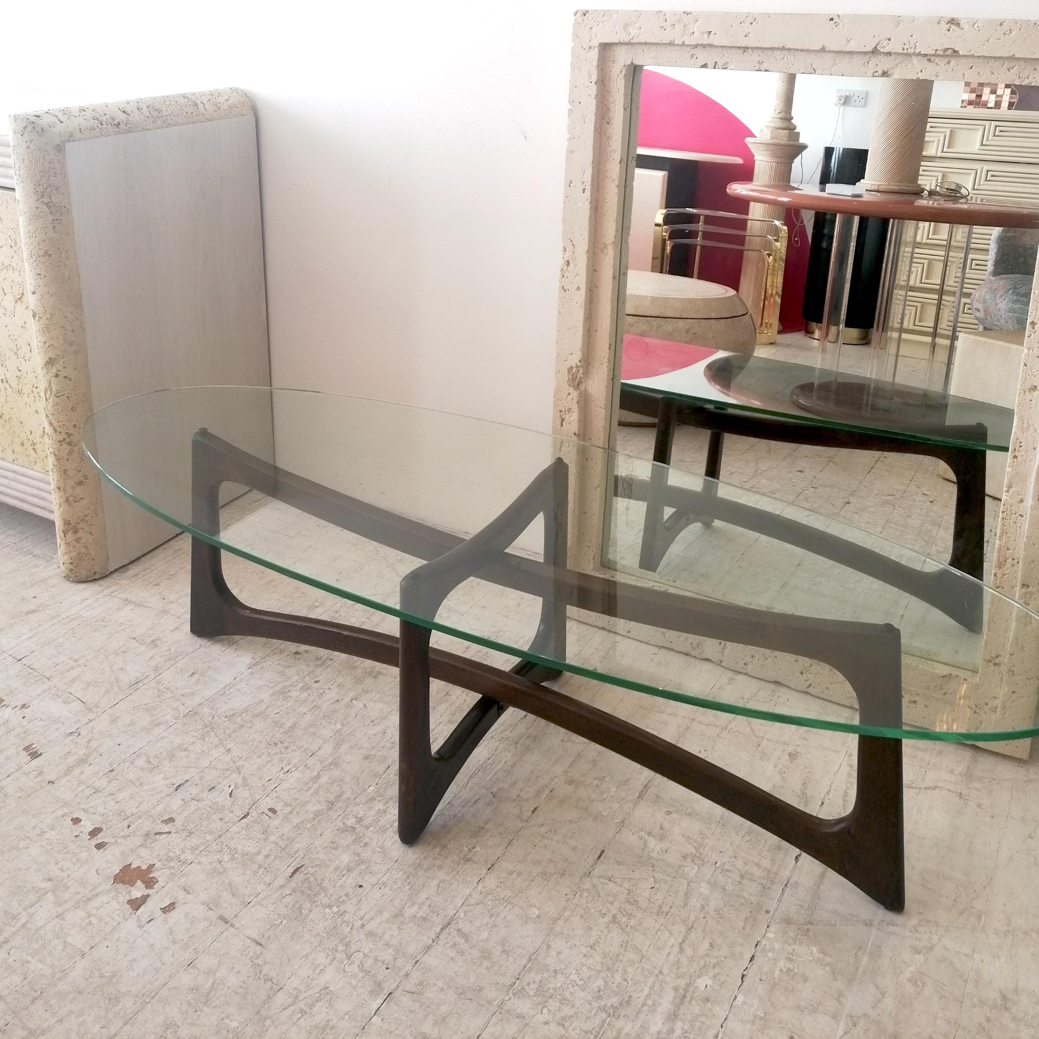A rare 'Ribbon' coffee table by renowned designer Adrian Pearsall for Craft Associates, USA 1960s. The sculptural walnut base supports a thick oval glass top. No maker's label, but it's a well-documented piece.

Dimensions: width 150cm, depth