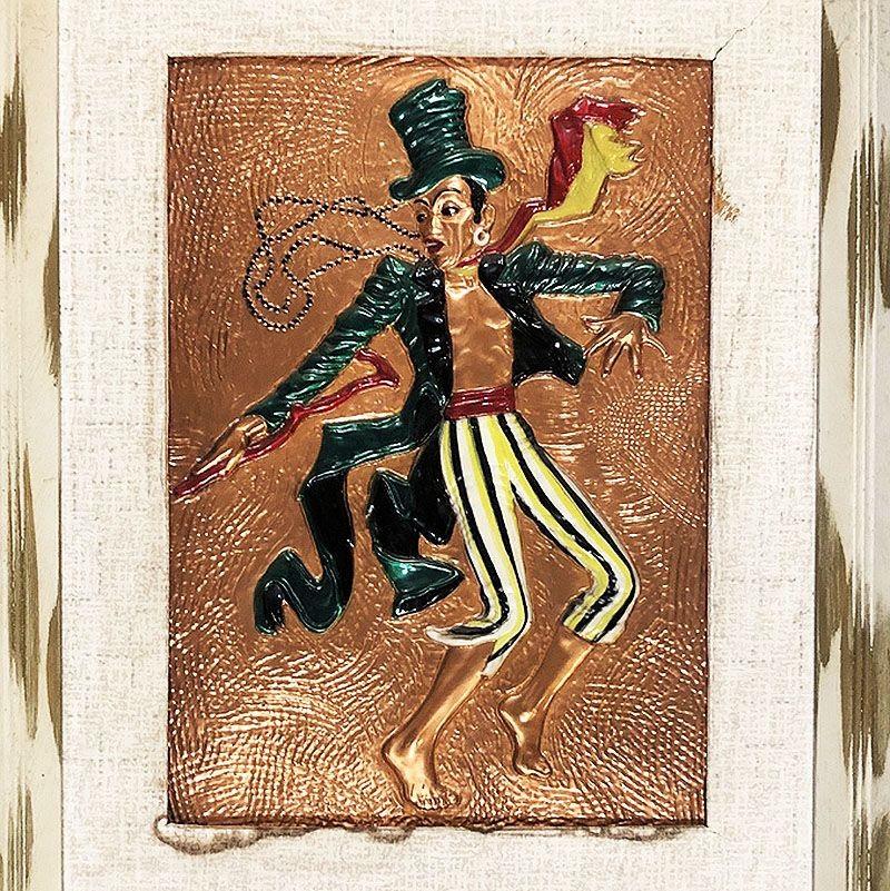 Copper Embossed Dancing Man wall sculpture, in original white painted wood frame. The wall art shows a ring master wearing a beetle green blazer and matching hat, yellow striped pants with a vibrant red and yellow scarf.

The copper artwork is