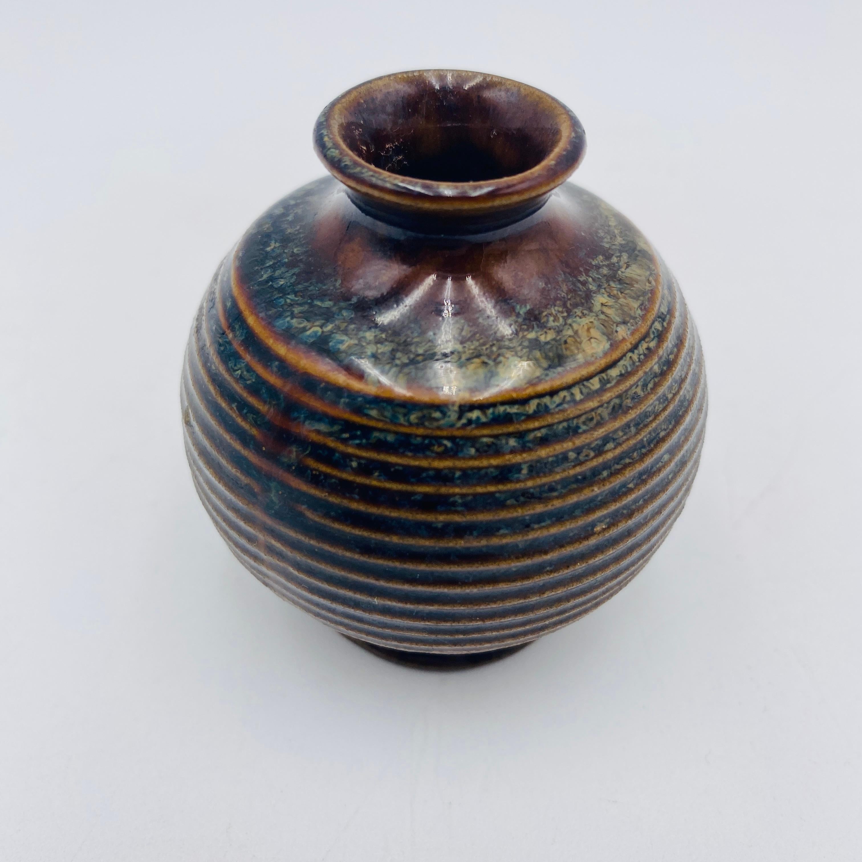 Cute little weed pot by Robert Maxwell. This tiny vase has a stamp that says, Robert Maxwell California Stoneware Handcrafted Designs. 