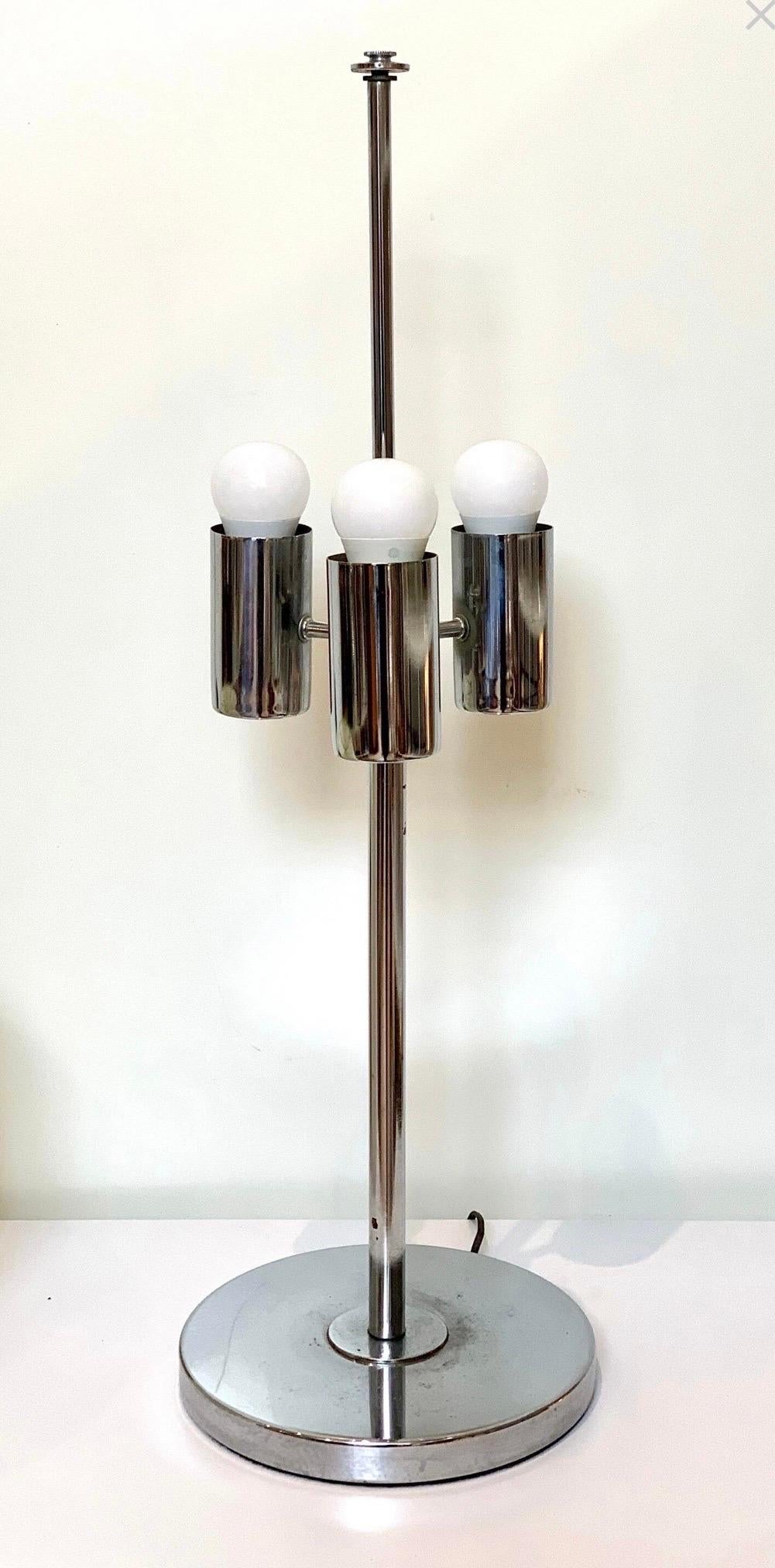 Mid-Century Modern chrome table lamp by Robert Sonneman with three lights and original shade. In excellent condition, with wear typical for age and use.

Lamp measures 10
