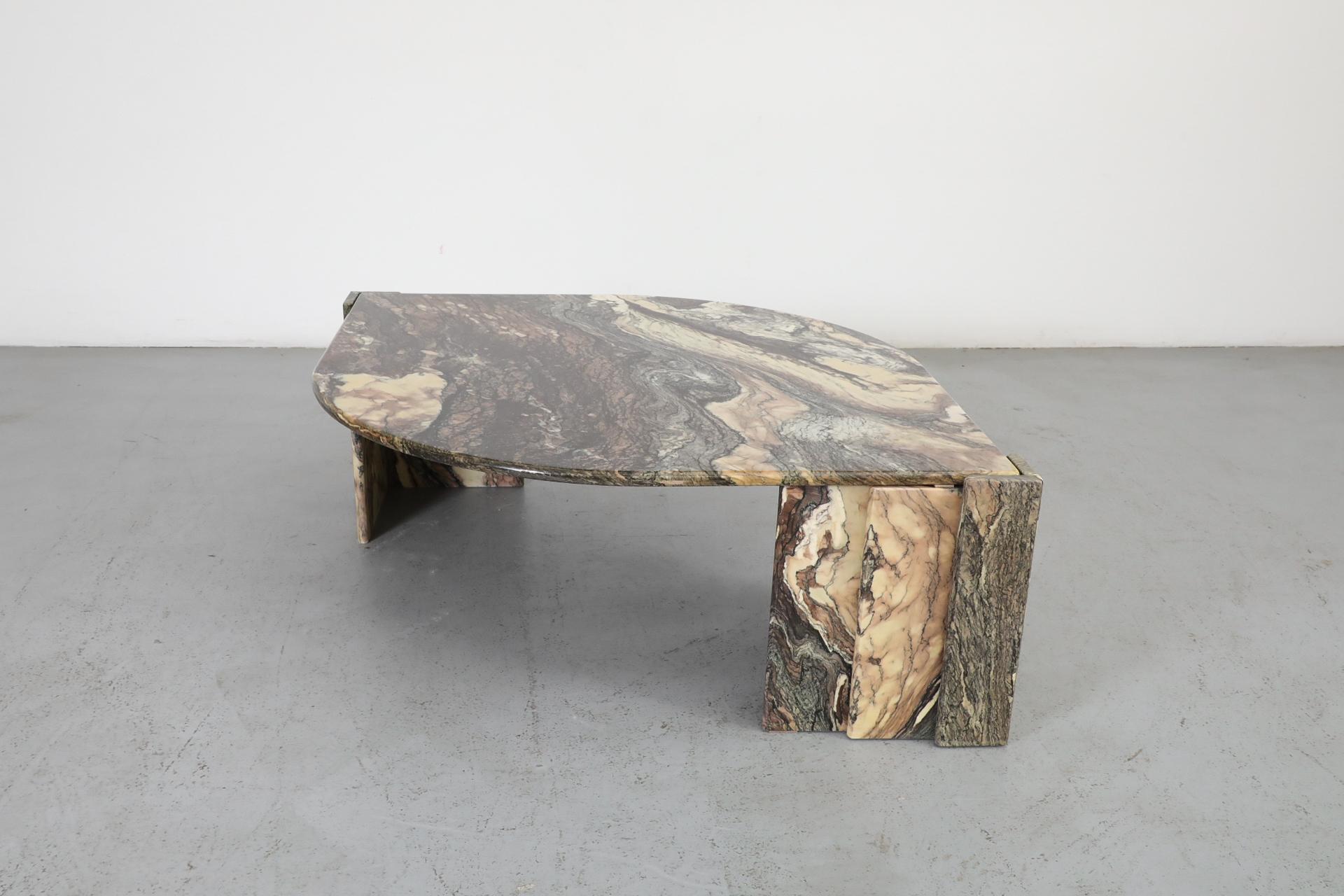Italian Mid-Century marble coffee table in Cipollino Ondulato marble. This striking table with unique swirling marble veining has an elegant cat's eye design and is attributed to Roche Bobois. In good original condition with visible wear consistent