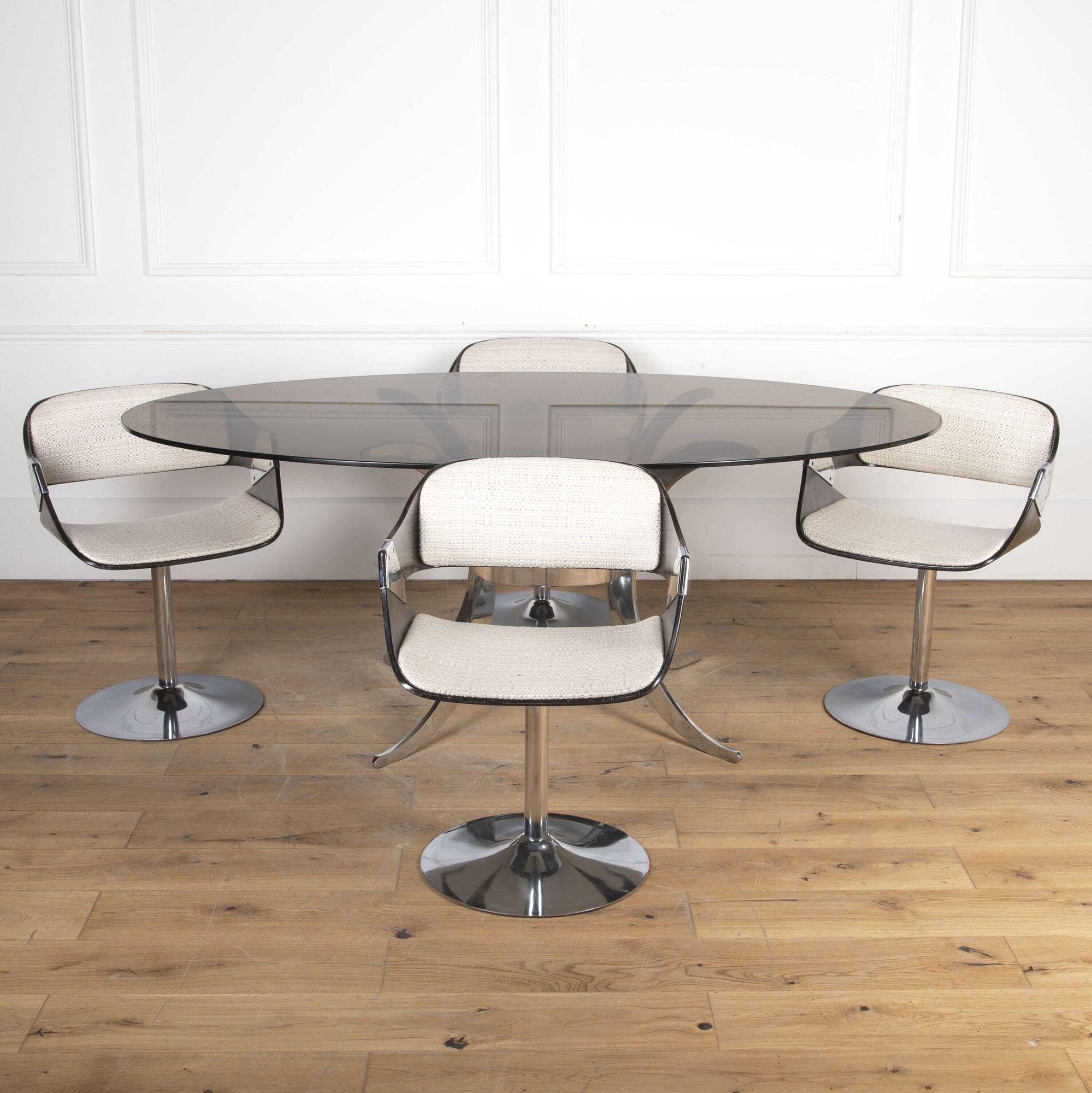 A wonderful Mid Century dining table and chairs made by Roche-Bobois.
The table has a chrome base with a smoked glass oval top.
The chairs have a swivel chrome base with upholstered seating and steam-bent ply backs.
Purchased in 1973 complete