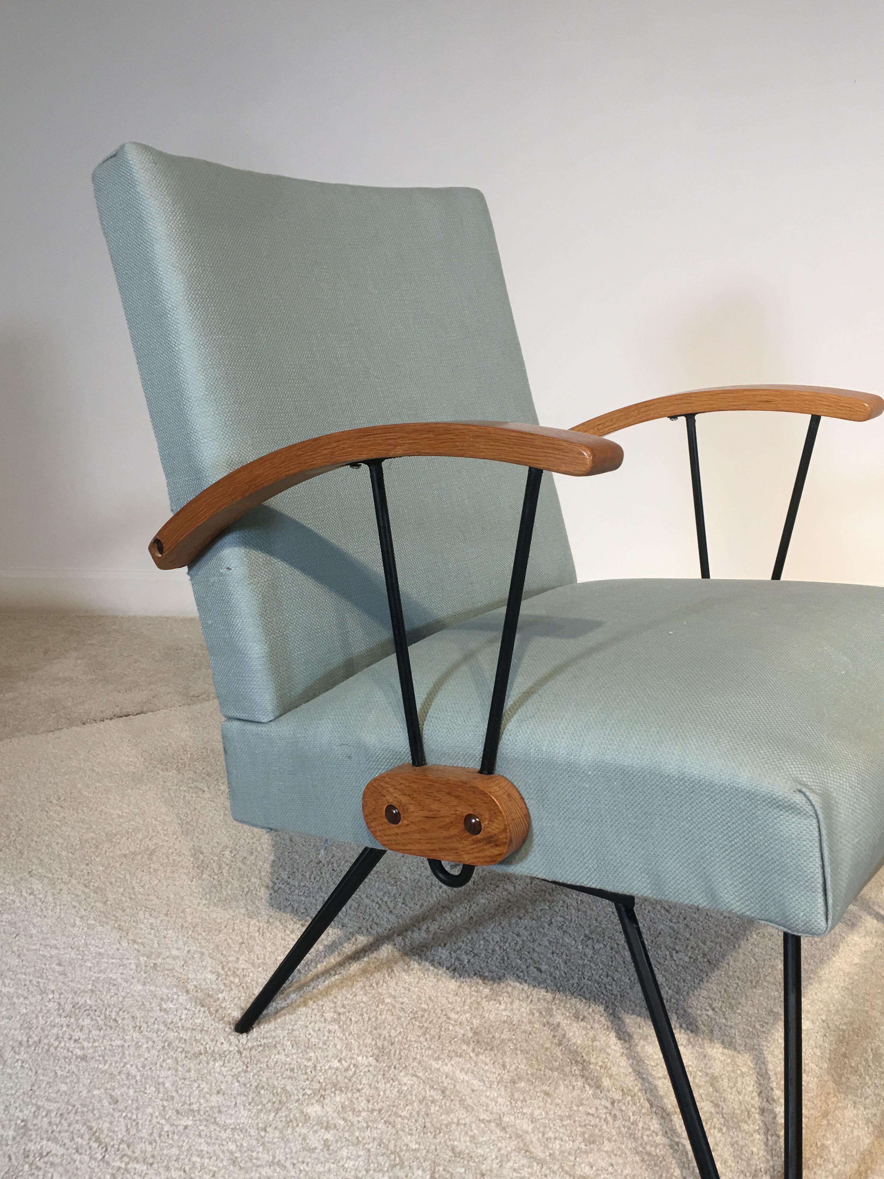 Simple and elegant rocking chair with ottoman in the style of Paul McCobb or Clifford Pascoe, circa 1940-1955. Features teal upholstery performed recently with the iron also recently painted. The arms are solid block wood, appears to be quarter sawn