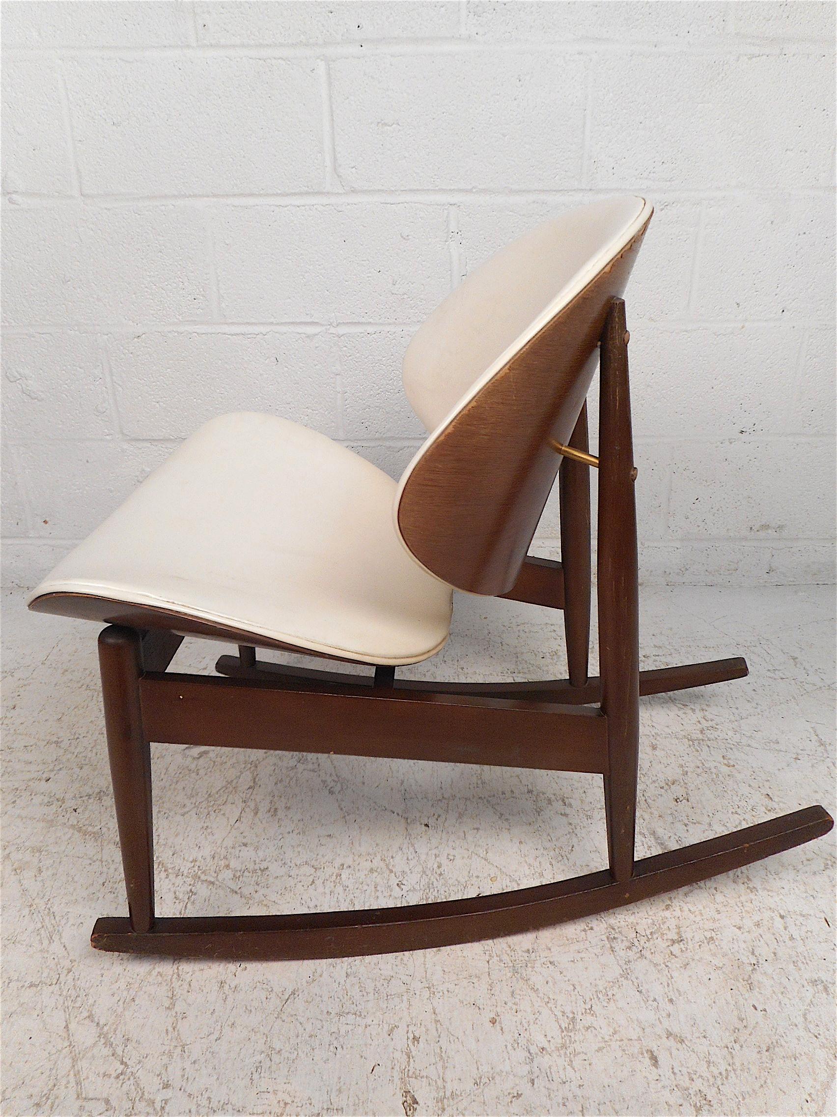 Unusual midcentury rocking chair manufactured by Kodawood Furniture. Interesting frame with bentwood frames on the seat and backrest, each covered in a vintage white faux-leather upholstery. Long and sturdy rocking runners underneath the chair.