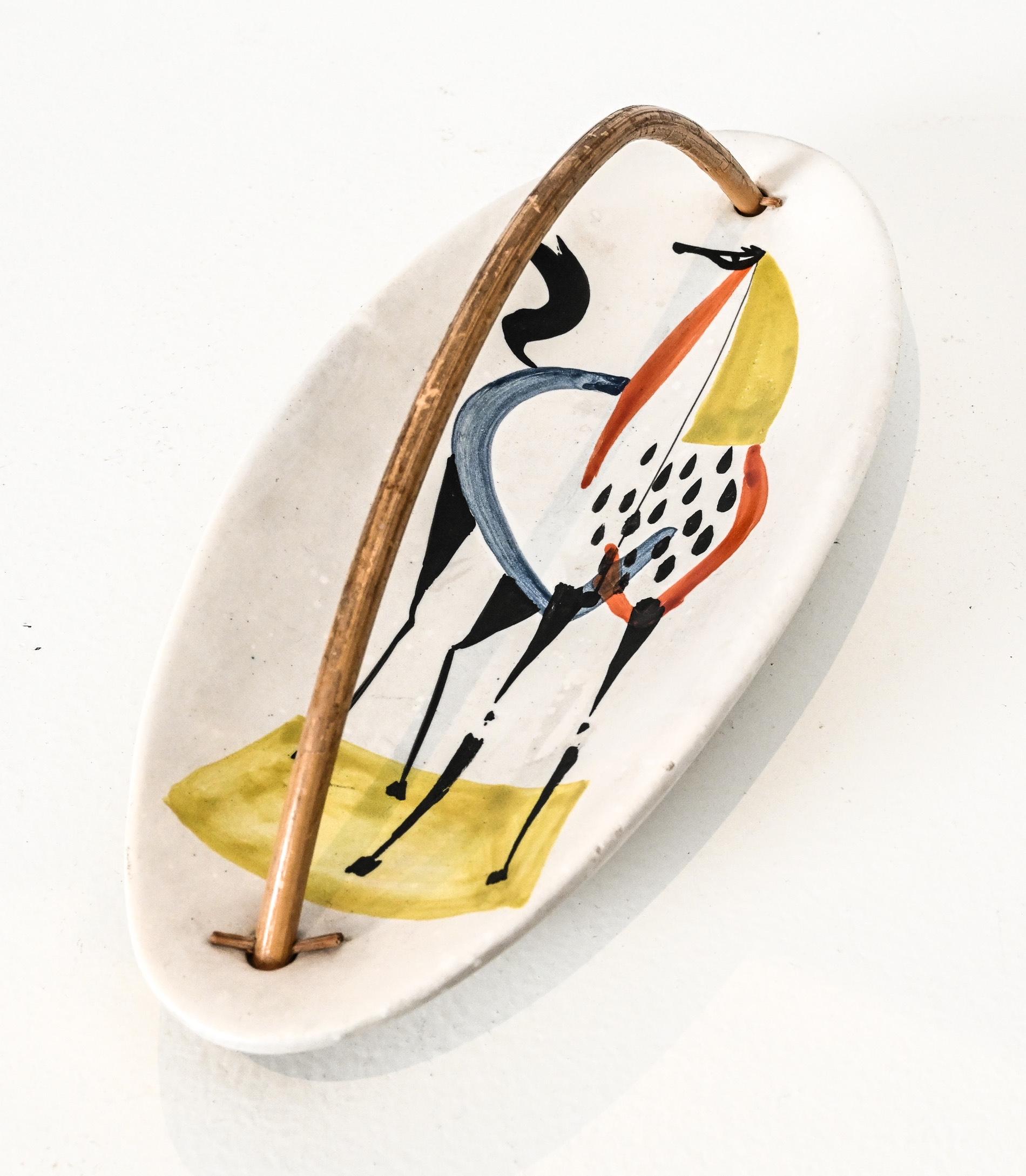 Oval shaped vide poche with bent bamboo handle.

Decorated with a medieval style horse in colours.
Signed ” Capron – Vallauris G” to the underside.
France circa 1955

midcentury Roger Capron ceramic vide poche quantity