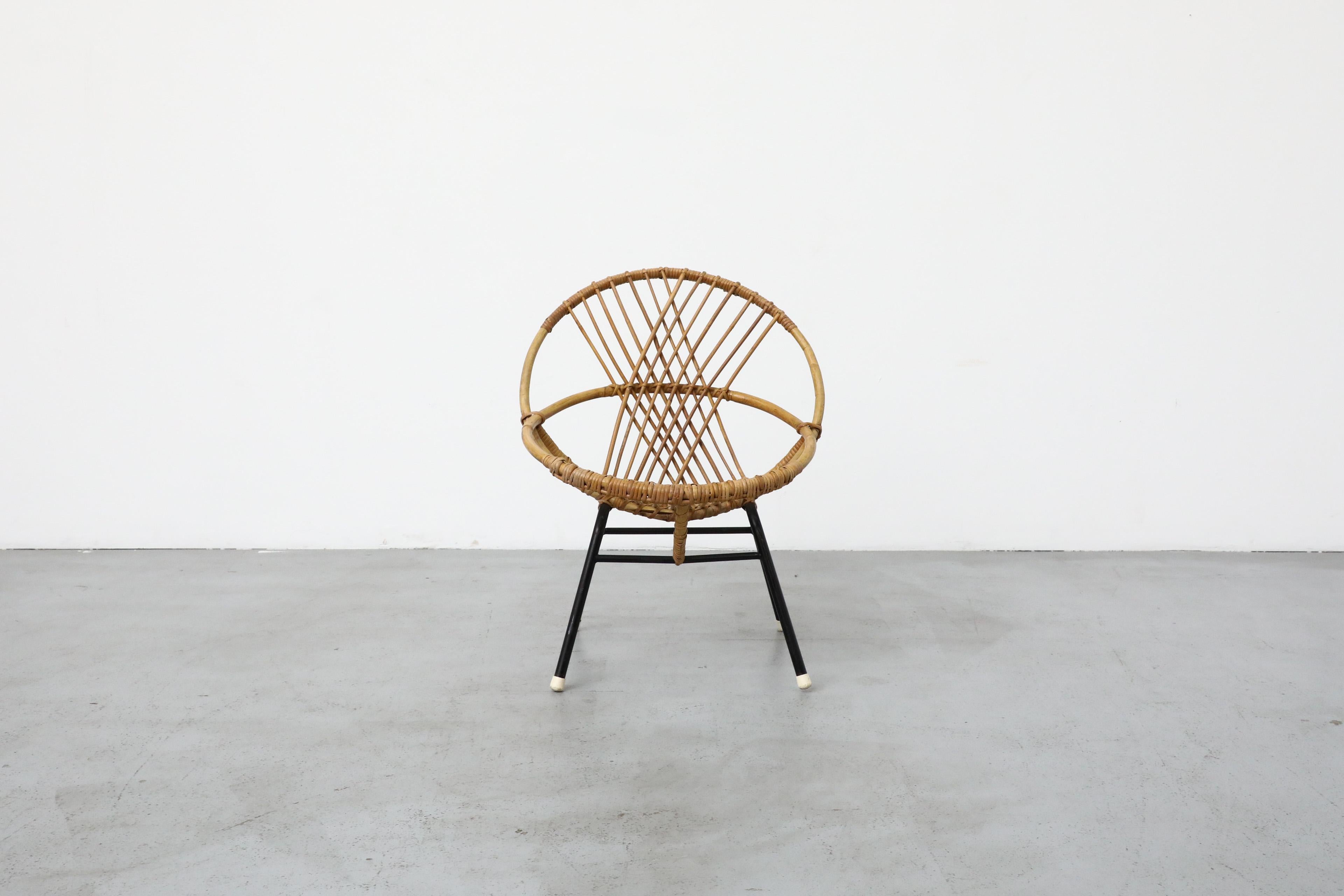 Mid-Century bamboo hoop chair by Rohe Noordwolde with black enameled frame and crossing bamboo back. In original condition with some visible wear and scratches consistent with its age and use. Perfect for use outdoors under a dry protected and