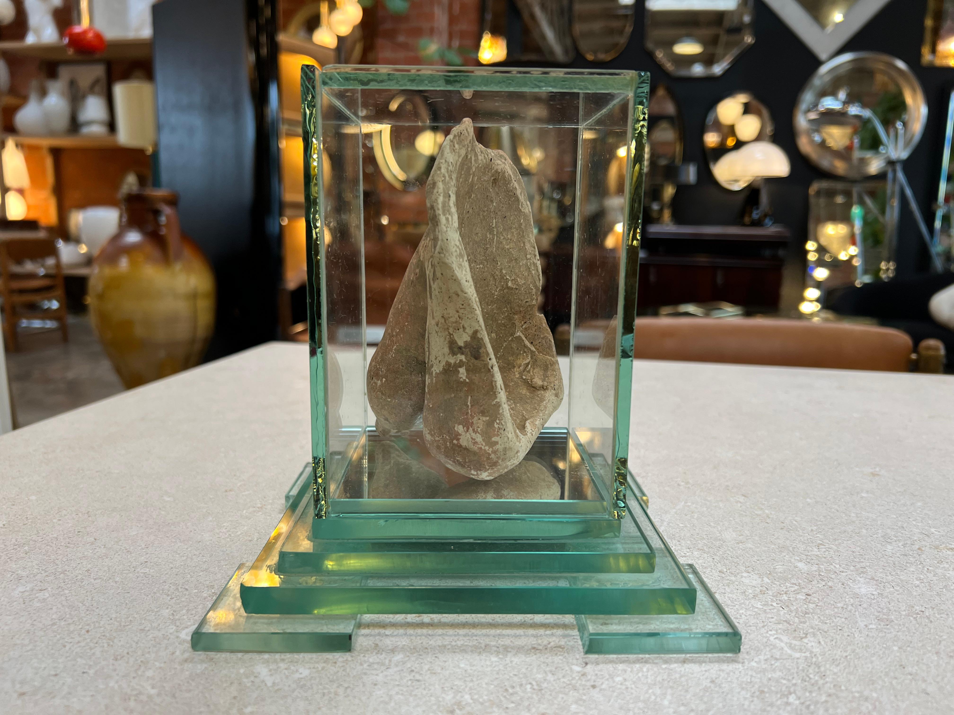 Introducing a provocative mid-century Roman sculpture from the 1940s - a daring representation of a stone penis encased in a cube of protective glass. This intriguing artwork challenges conventional norms, exploring themes of art, sexuality, and