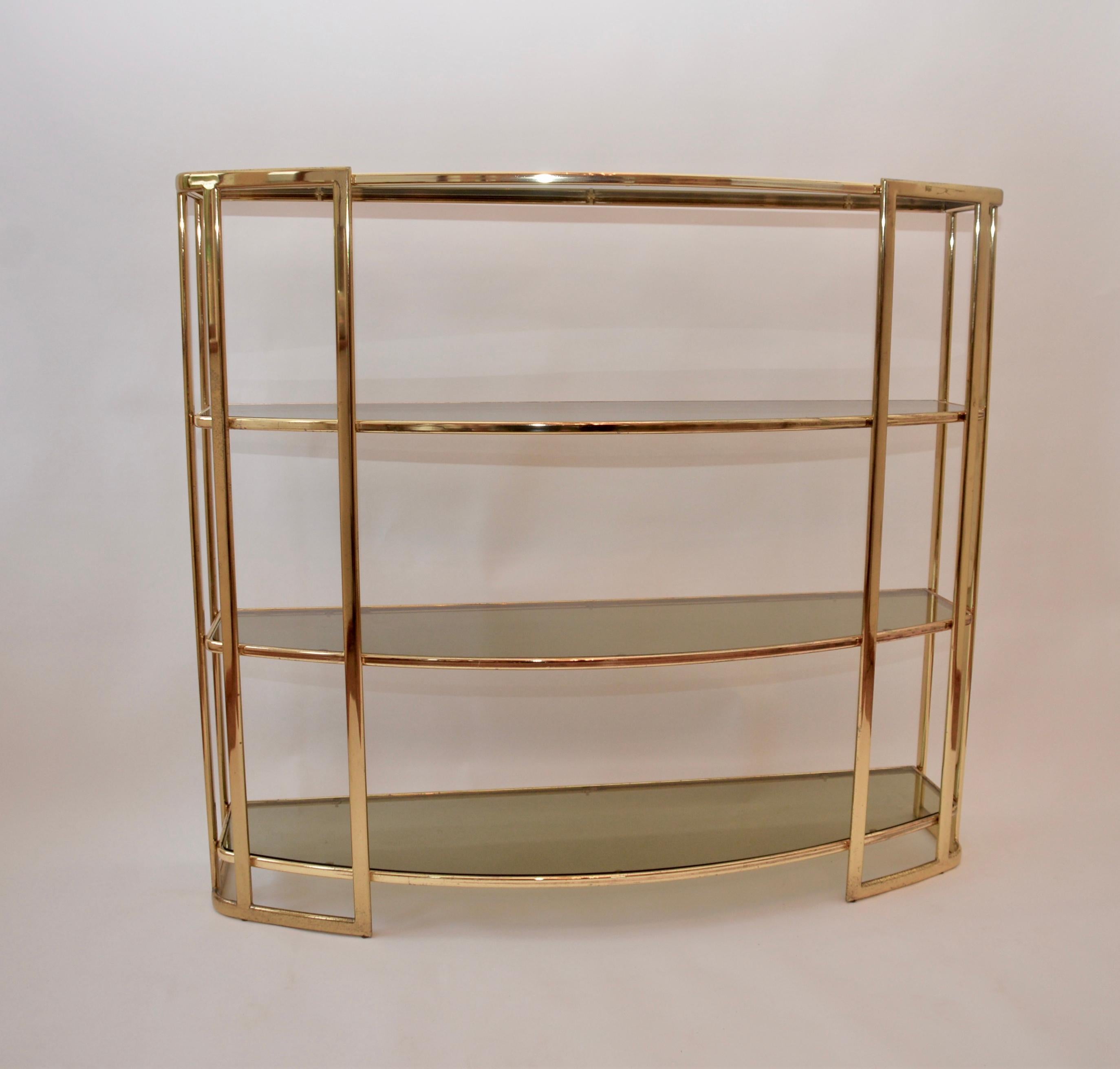 A midcentury Romeo Rega étagère, Renato Zevi 1970s piece. Lovely brass frame with tinted glass shelves. There is a genuine label to the base of the item.