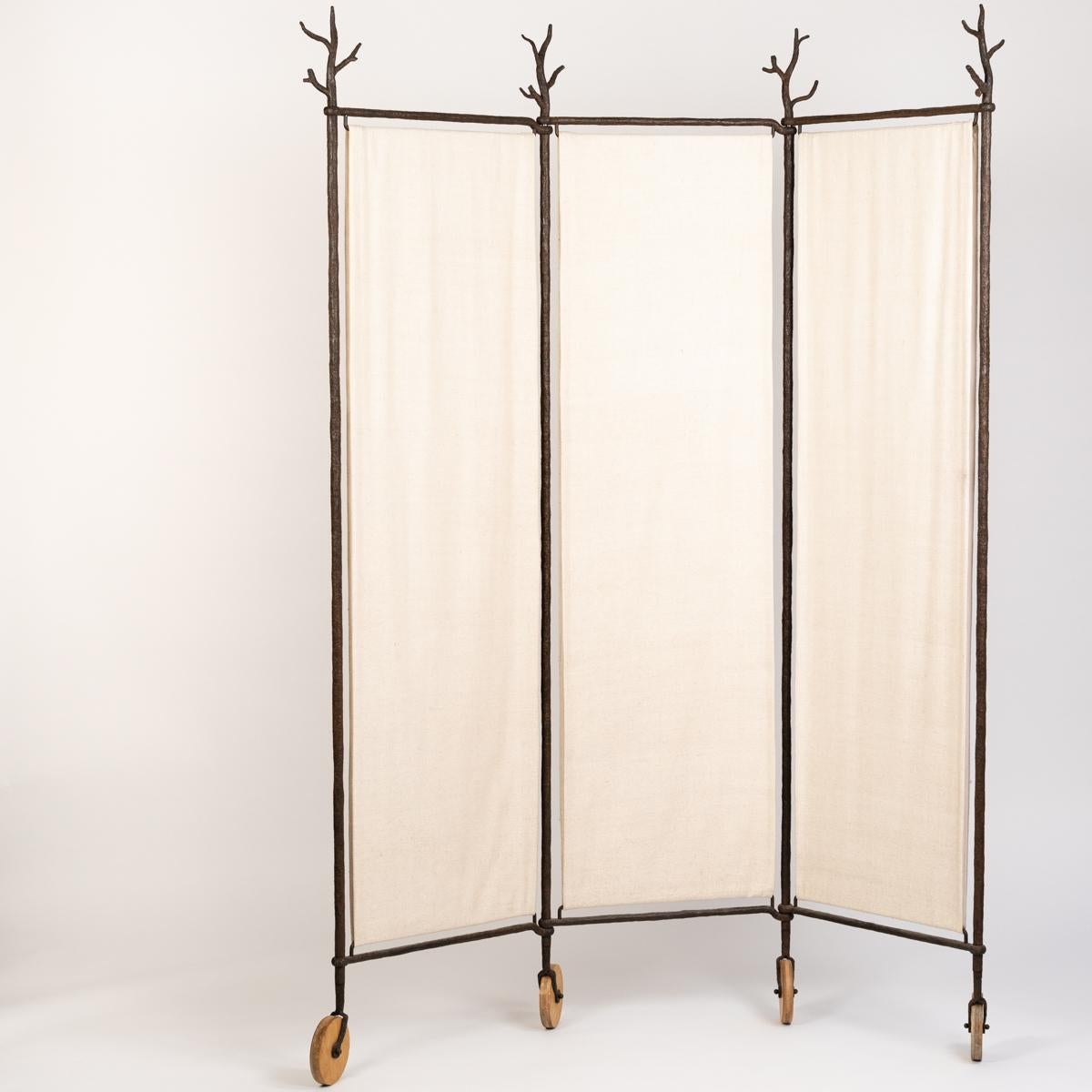 Screen in iron with heavy linen fabric covering by Stefan Herzog.
The naturalistic object has a poetic touch and recalls the works of Garouste and Bonetti.
The iron parts have a certain rusticity, the pores are open, making them look almost like
