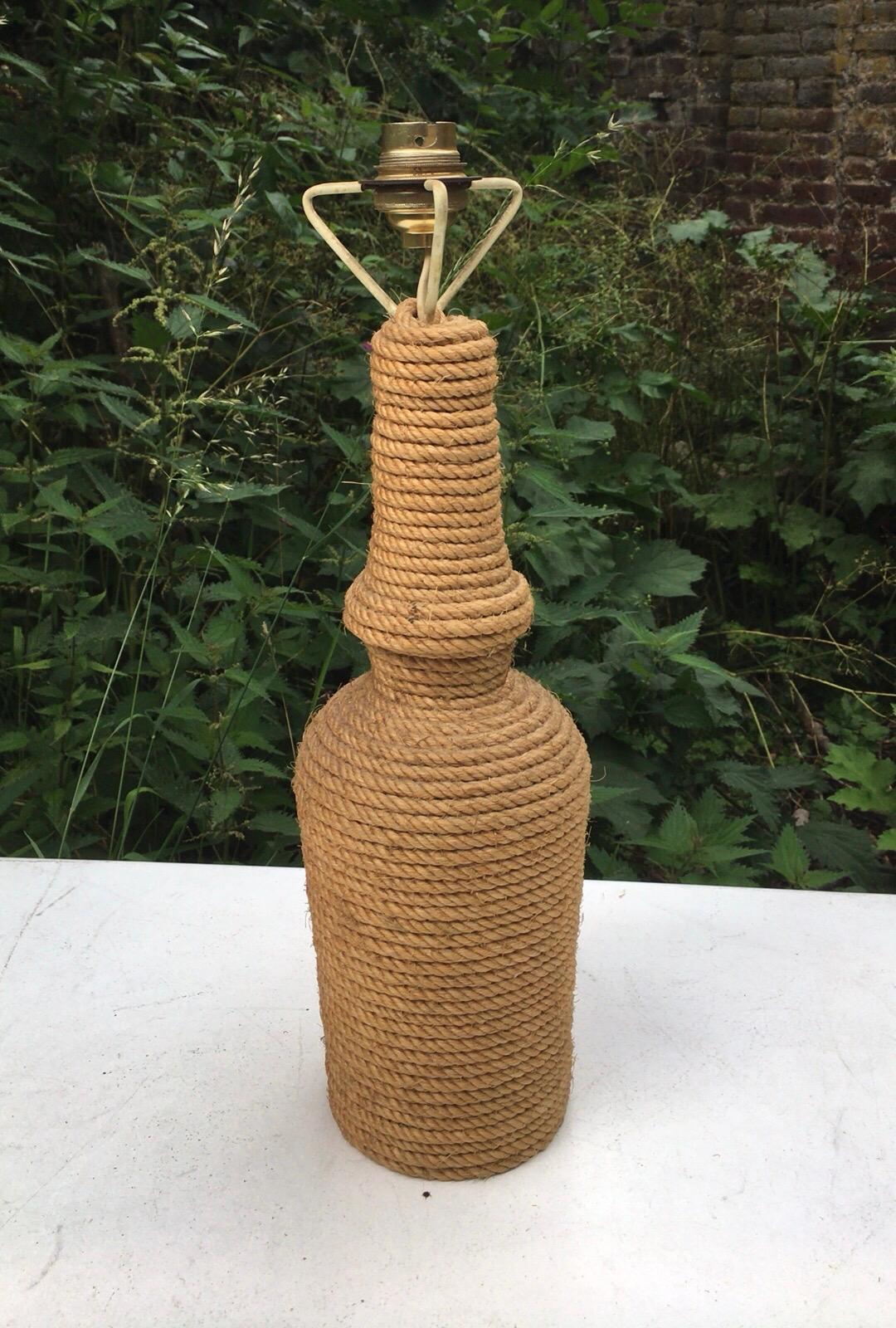 Mid-century rope bottle lamp by Audoux Minet.
With a green glass 
Measures: Height : 20 inches.
Diameter : 5 inches.
 