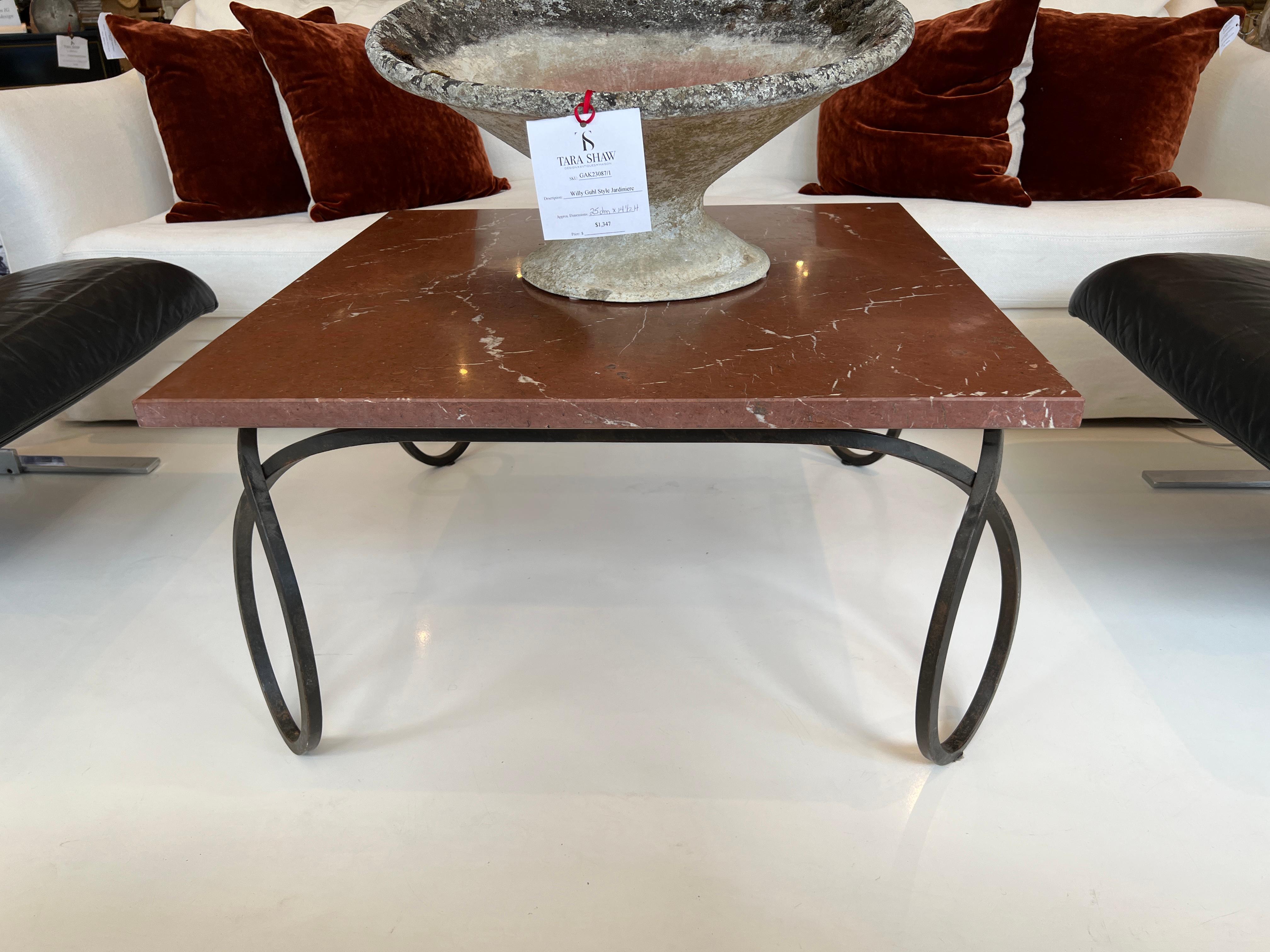 Large looped legs in wrought iron support a handsome slab of red Marble. Beautiful, generously sized statement piece.