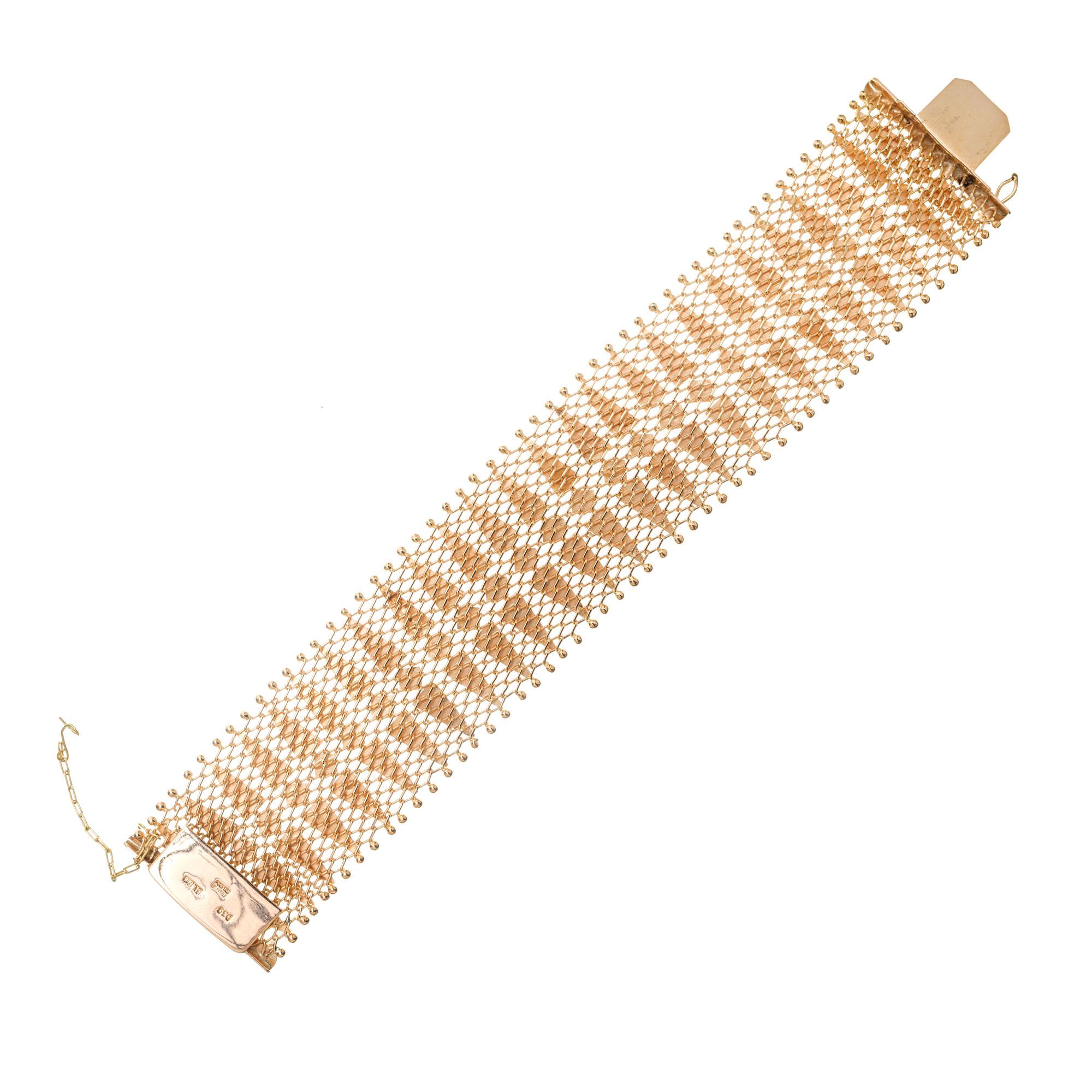 1950's 1.25 Inch wide 18k rose gold bracelet from Argentina. Figure 8 safety chain. 7.25 inches in length. 

18k rose gold 
Stamped: 18k 750
Hallmark: Argentina 
54.9 grams
Total length: 7.25 Inch
Width: 34.0mm
Thickness/ depth: 4.0mm

