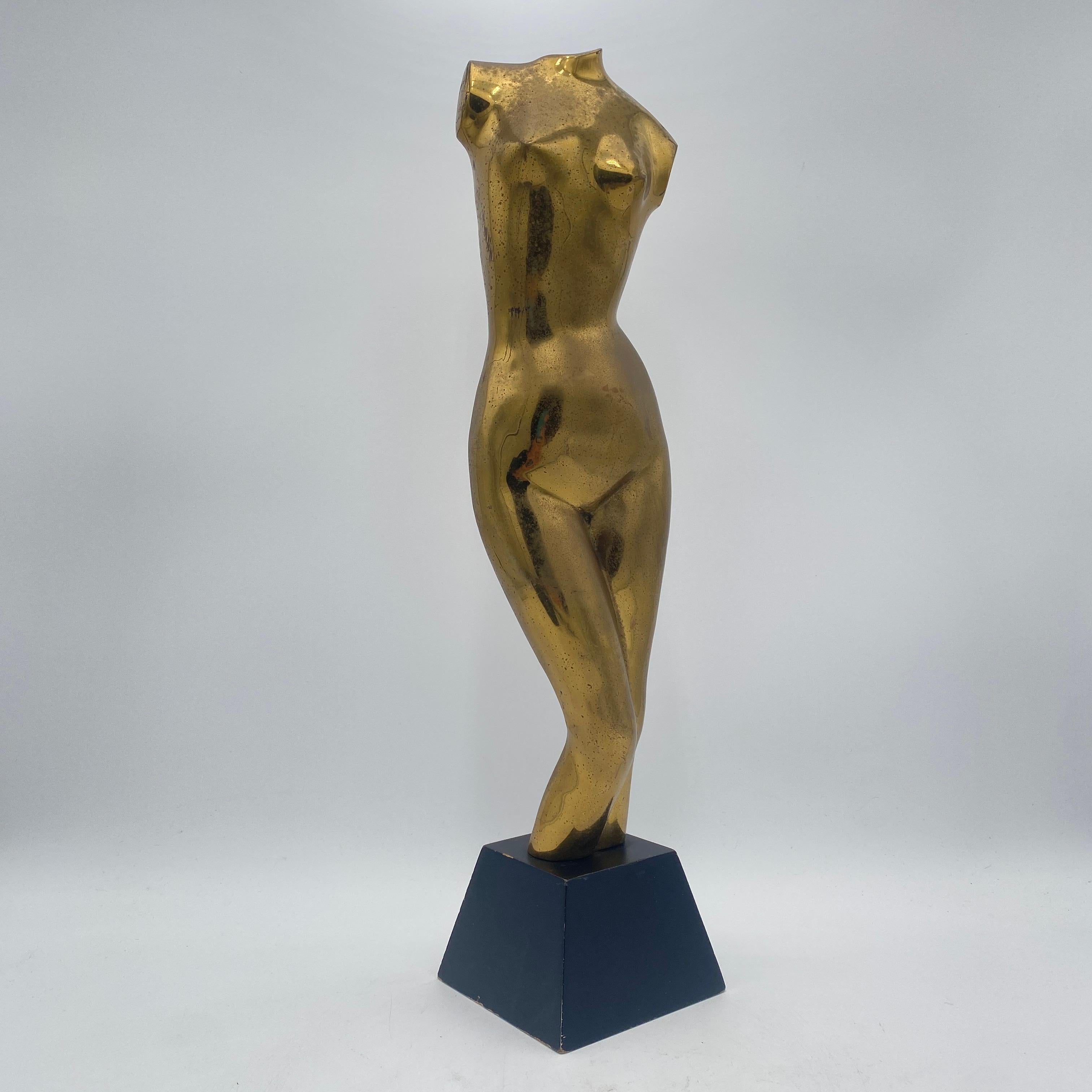 A mid-century Rosenthal Netter nude sculpture in brass on a black wood base made circa the 1960s. 