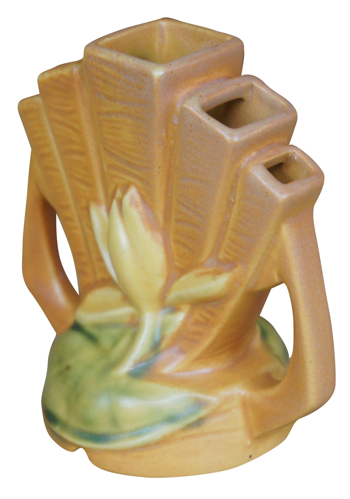 Mid century Roseville Pottery water lily flower frog or bud vase featuring orange glaze with five fingers and floral motif. Circa 1940s. Measure: 48 5