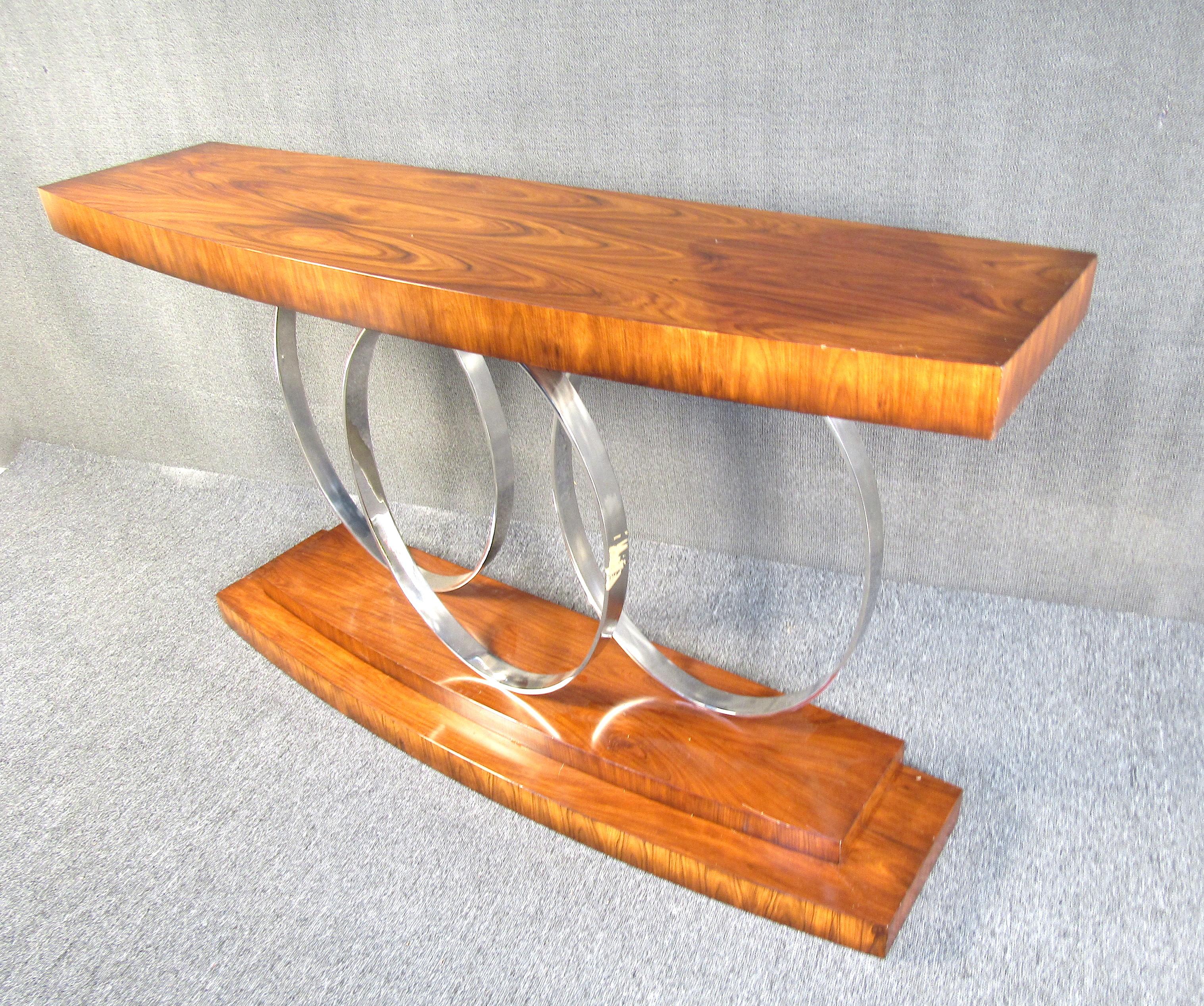 This impressive console table is both elegant in appearance and functional in design. Featuring rosewood this table will catch someone's eye from well across the room. With beautiful hues of red that are complemented by the chrome, this piece will