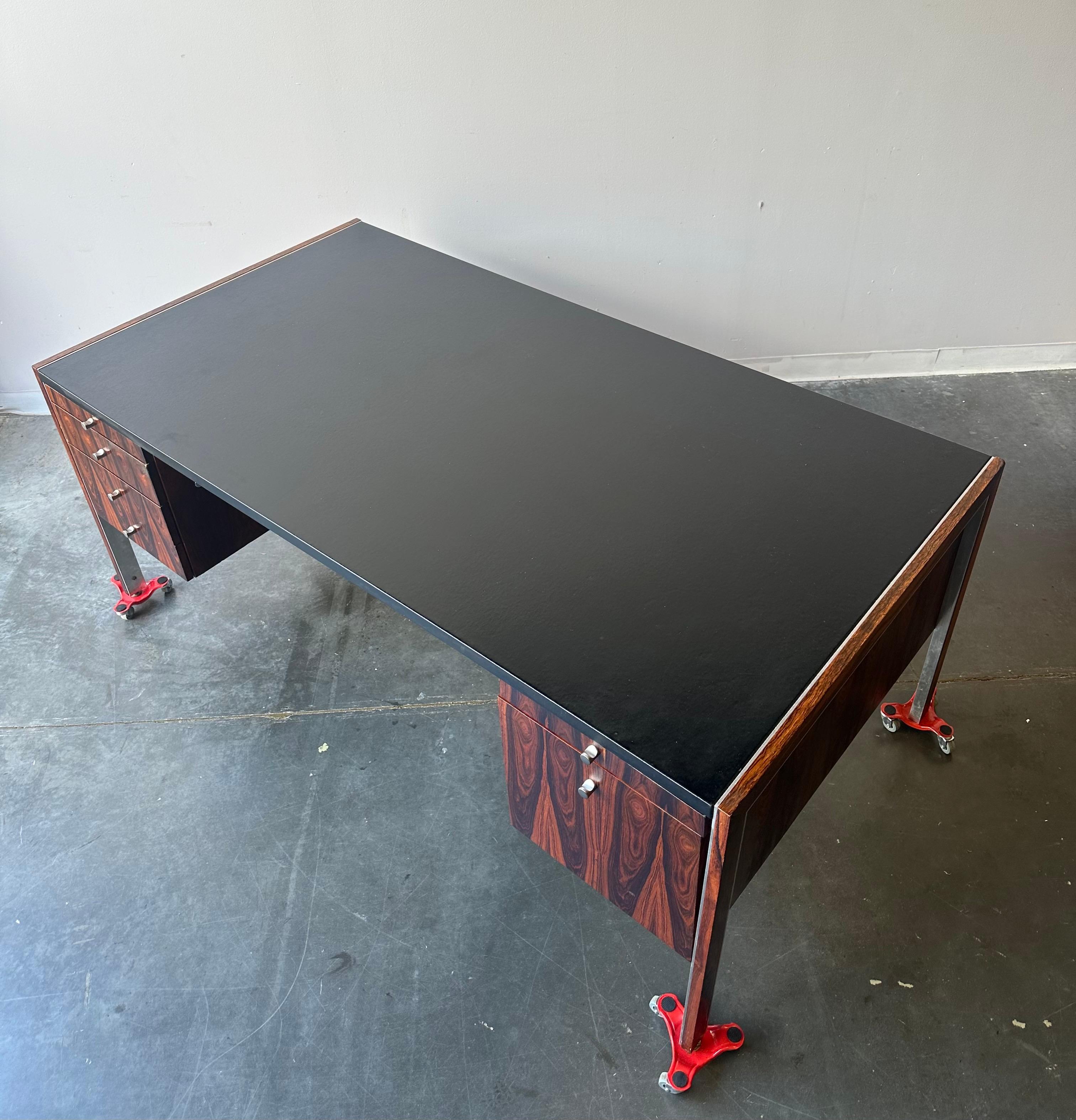 Mid Century Rosewood And Leather Executive Desk By Herman Miller for Biltrite Canada, Circa 1970

Stunning vintage x-large office desk that’s rosewood with a leather top and chrome accents.

This is attributed to Herman Miller as he was commissioned