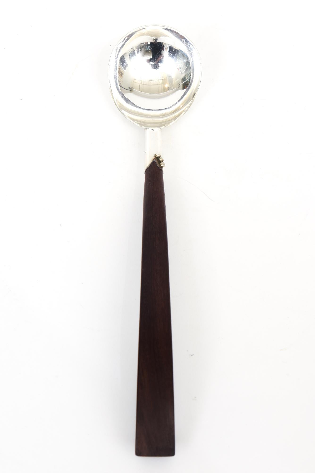 This beautiful mid century modern 1940's hallmarked sterling silver and rosewood sculptural serving spoon is very Spratling style. it is marked Sterling A Mexico. There are 3 tiny ball forms at end of neck where rosewood handle comes in.