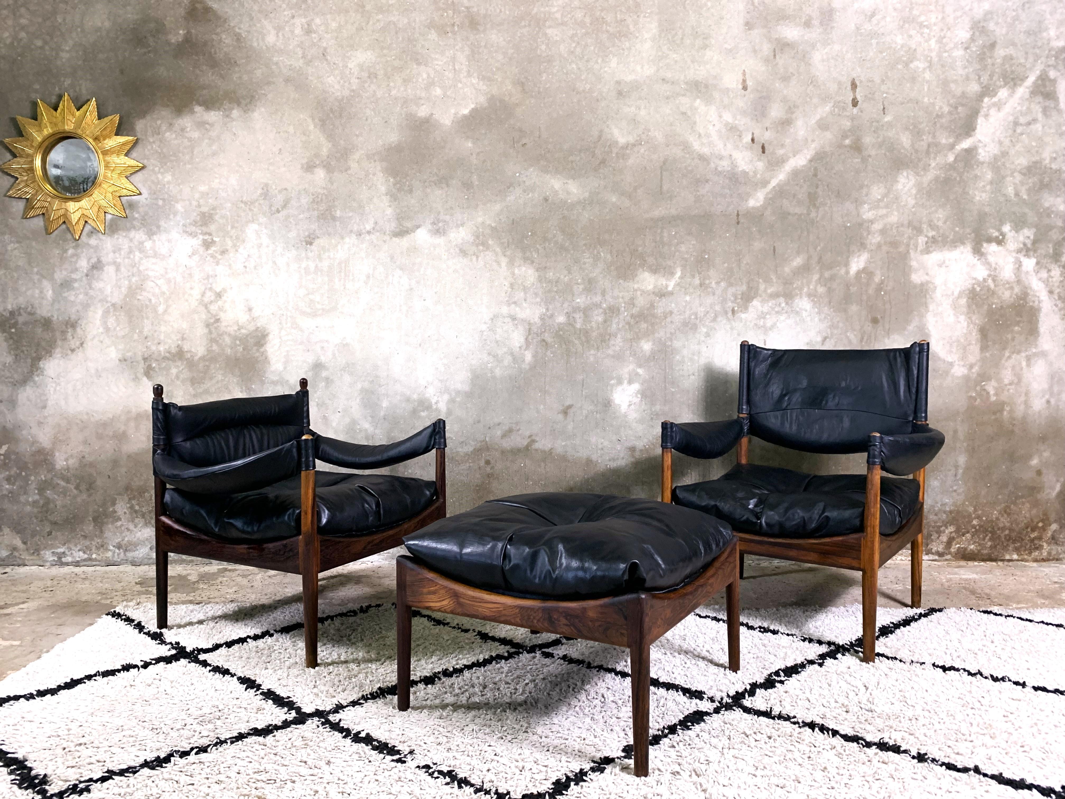 A beautiful set of two armchairs and a footstool from the Modus series, designed by Kristian Vedel for Willadsen Møbelfabrik. Wooden frames made of rosewood. Natural leather cushions and goose feather filling make the armchairs exceptionally