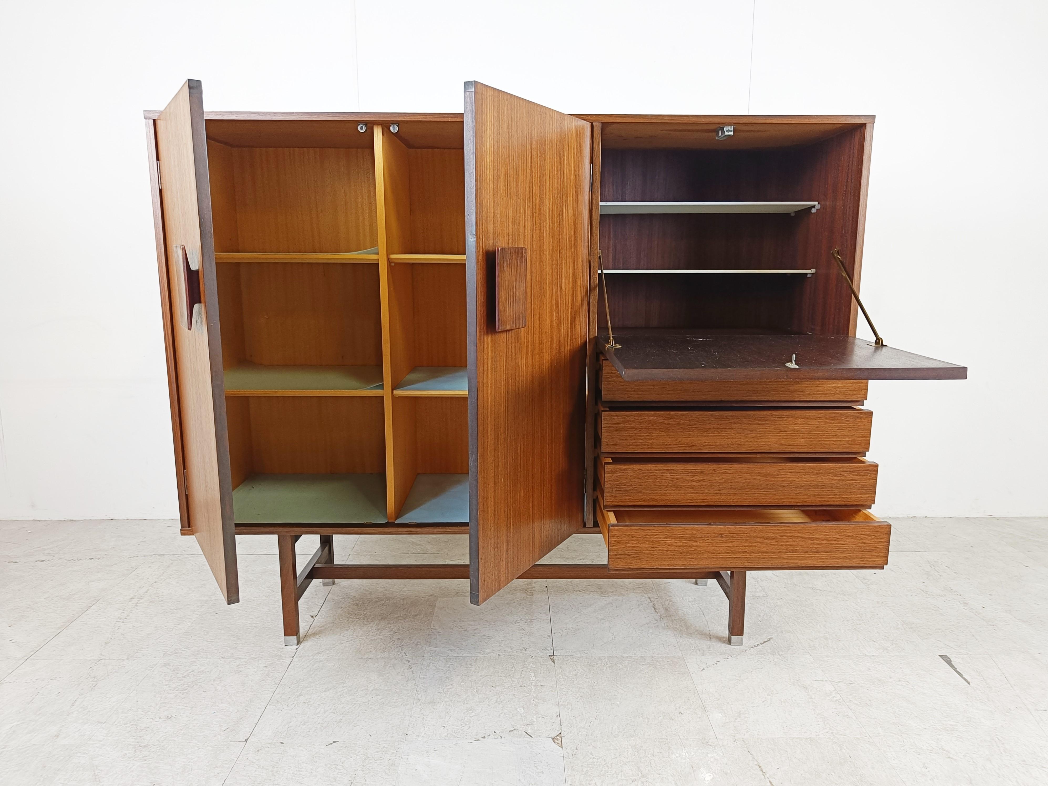 Scandinavian design rosewood bar cabinet by Inger Klingenberg for Fristho.

Simple yet elegant design.

The cabinet consists of two door, 4 drawers and a fold down door with white glass shelves.

1960s - Denmark

good overall condition apart from