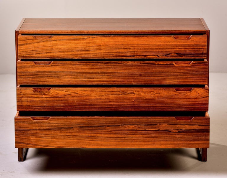 Circa 1960s four drawer rosewood veneered chest designed by Svend Langkilde for Langkilde of Denmark. Top drawer is divided, legs are metal. Versatile size can be used to flank a sofa or bed. Manufacturer’s mark on back. Very good overall vintage