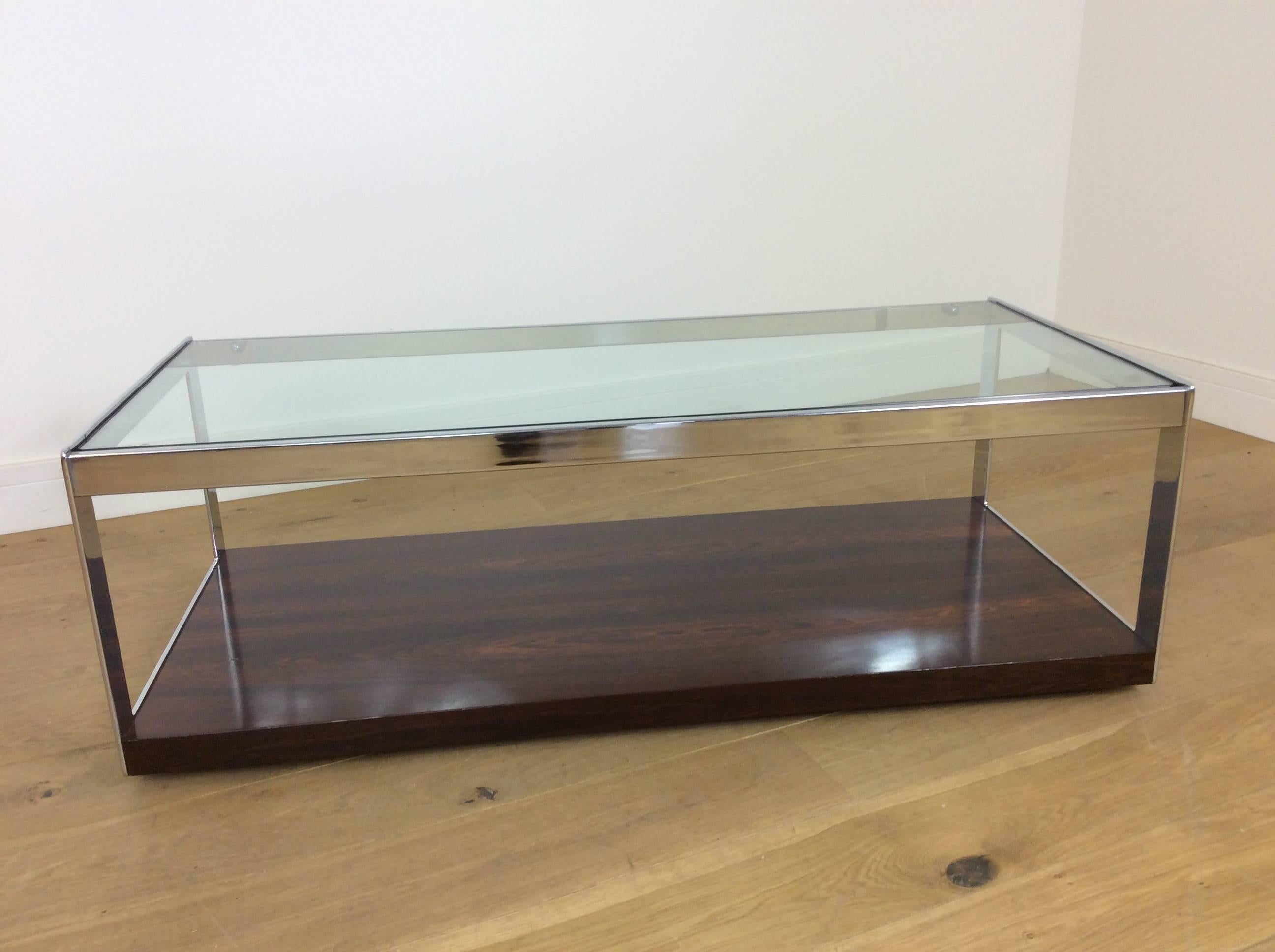 Beautiful rosewood and glass long coffee table on castors.
Fine high quality flat chrome frame, heavy plate glass top and beautiful rosewood base.
Classic midcentury Furniture. Designed by Richard Young for Merrow Associates.
Measures: 40 cm H,