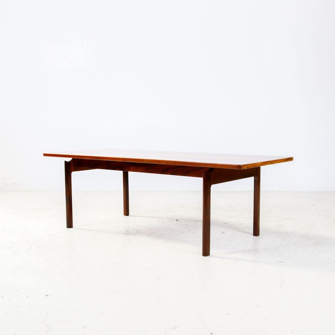 A vintage 1960s coffee table made of luxurious rosewood. It has a beautiful organic finish in the base. The table is in good vintage condition, with slight signs of use and a nice patina.