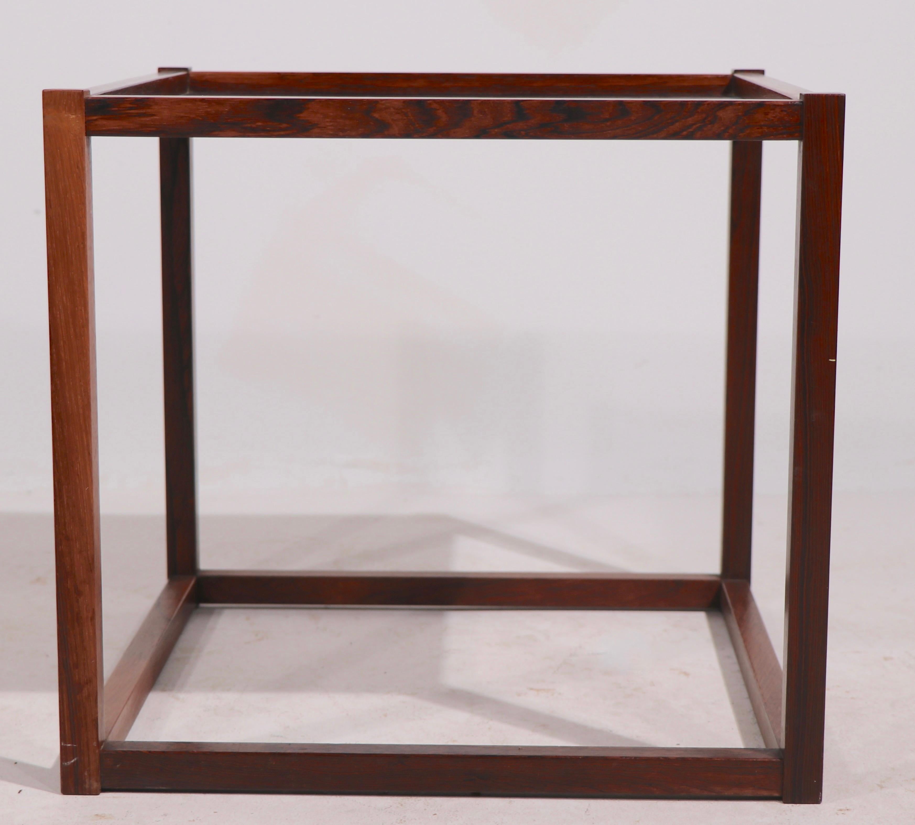 Rare rosewood cube table in the Minimalist, Danish Modern style. The table has a textured black top surface, and a rosewood structure. Original, clean, ready to use, in the style of Kai Kristiansen, unsigned.
