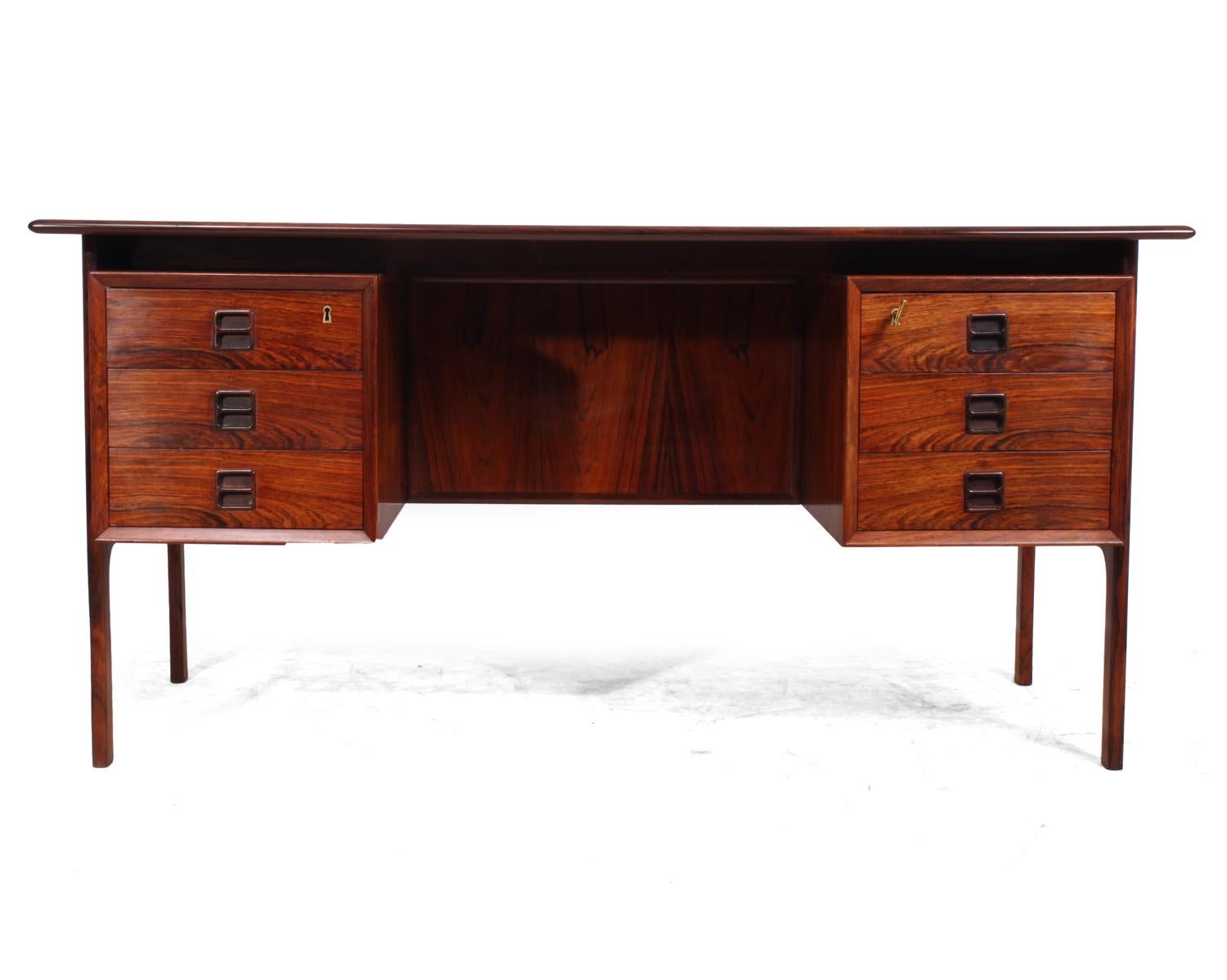 Midcentury rosewood desk by Arne Vodder
A midcentury desk produced in Denmark in the 1960s by Arne Vodder, it has six drawers top drawers are lockable 1 key supplied they have inset sculpted handles, and floating top, the desk is in excellent
