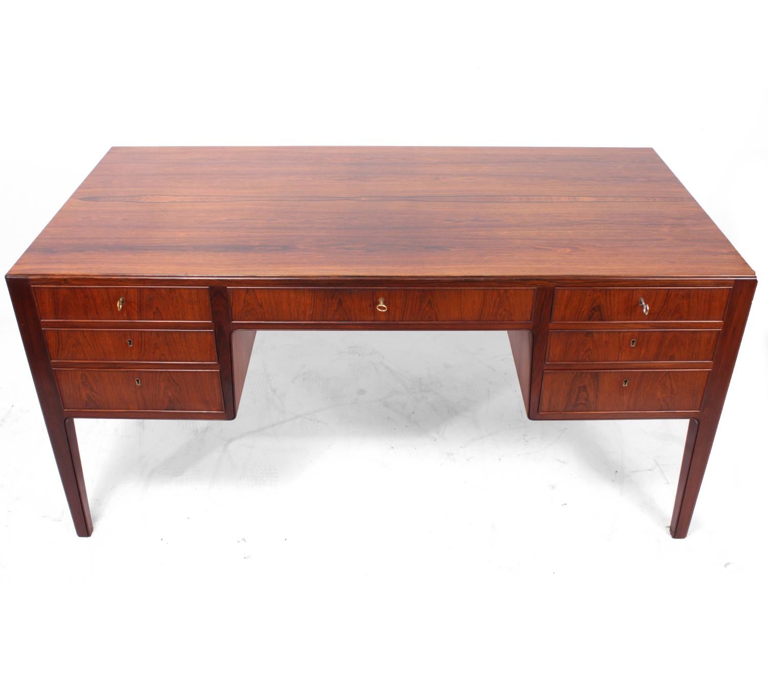 Midcentury rosewood desk Danish, circa 1950
A high quality Danish produced desk with seven drawers and two cupboards to the rear, the drawers are oak with hand cut dovetail and solid rosewood cockbead with inset locks the three keys supplied fit