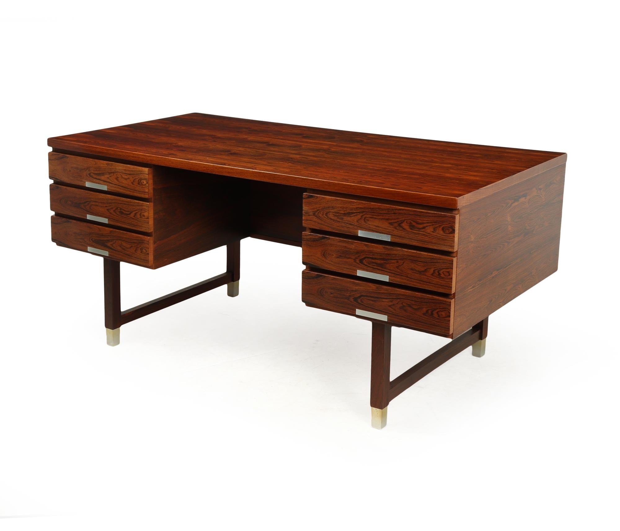 A very stylish desirable rosewood desk produced in the 1960’s by Eigil Petersens Møbelfabrik often having been mistaken for a model by Kai Kristansen The Desk has six drawers and open bookshelf divided into three to the back making it completely