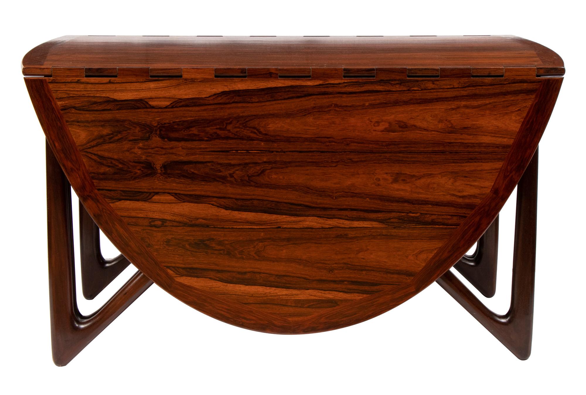 midcentury rosewood dining table by Niels Koefoed. Drop leaf top with Hinge joints opening to a maximum 195cm x 73cm.Organic V shaped legs.Often listed as by Kurt Ostervig but recent research suggests Niels Koefoed was the designer and this table