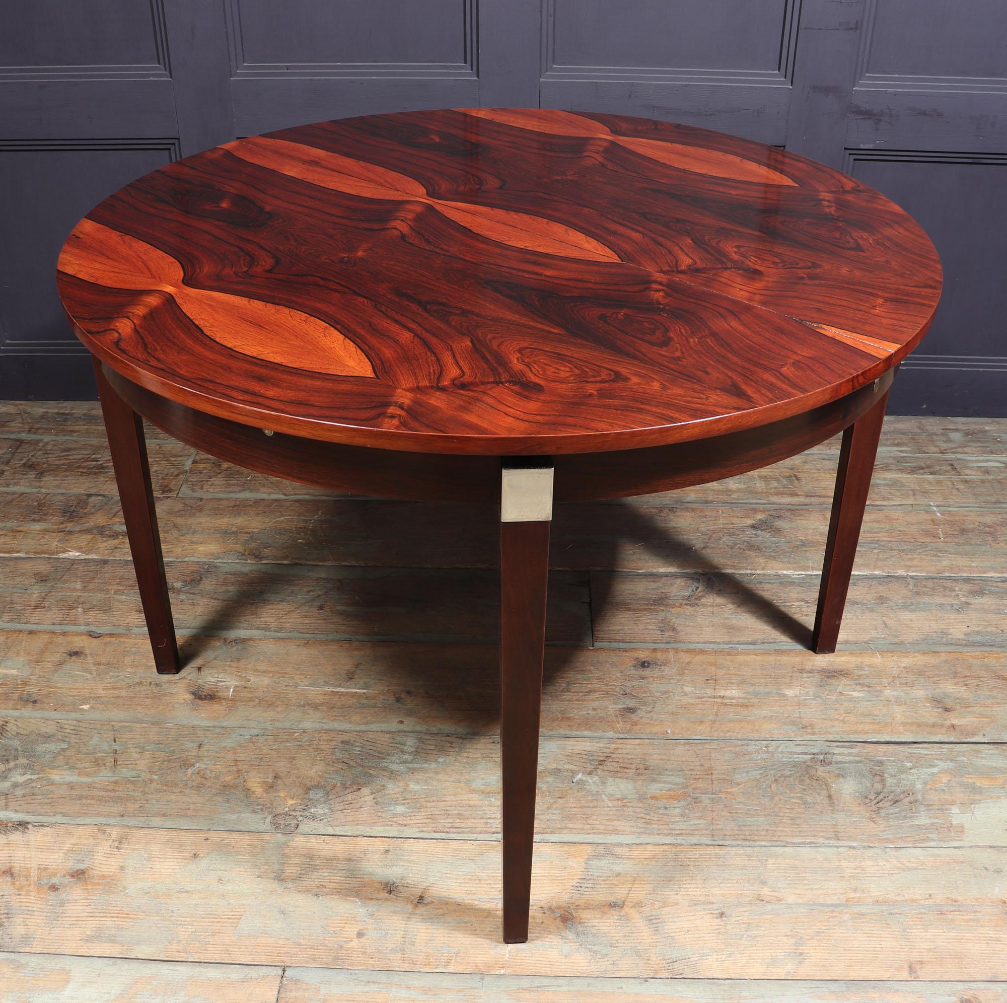 Midcentury dining table.
A midcentury extending circular dining table produced in France in the 1960s, it has mahogany square tapered legs with chromed steel detail to the top. The extendable top is rosewood that opes to reveal a butterfly leaf so
