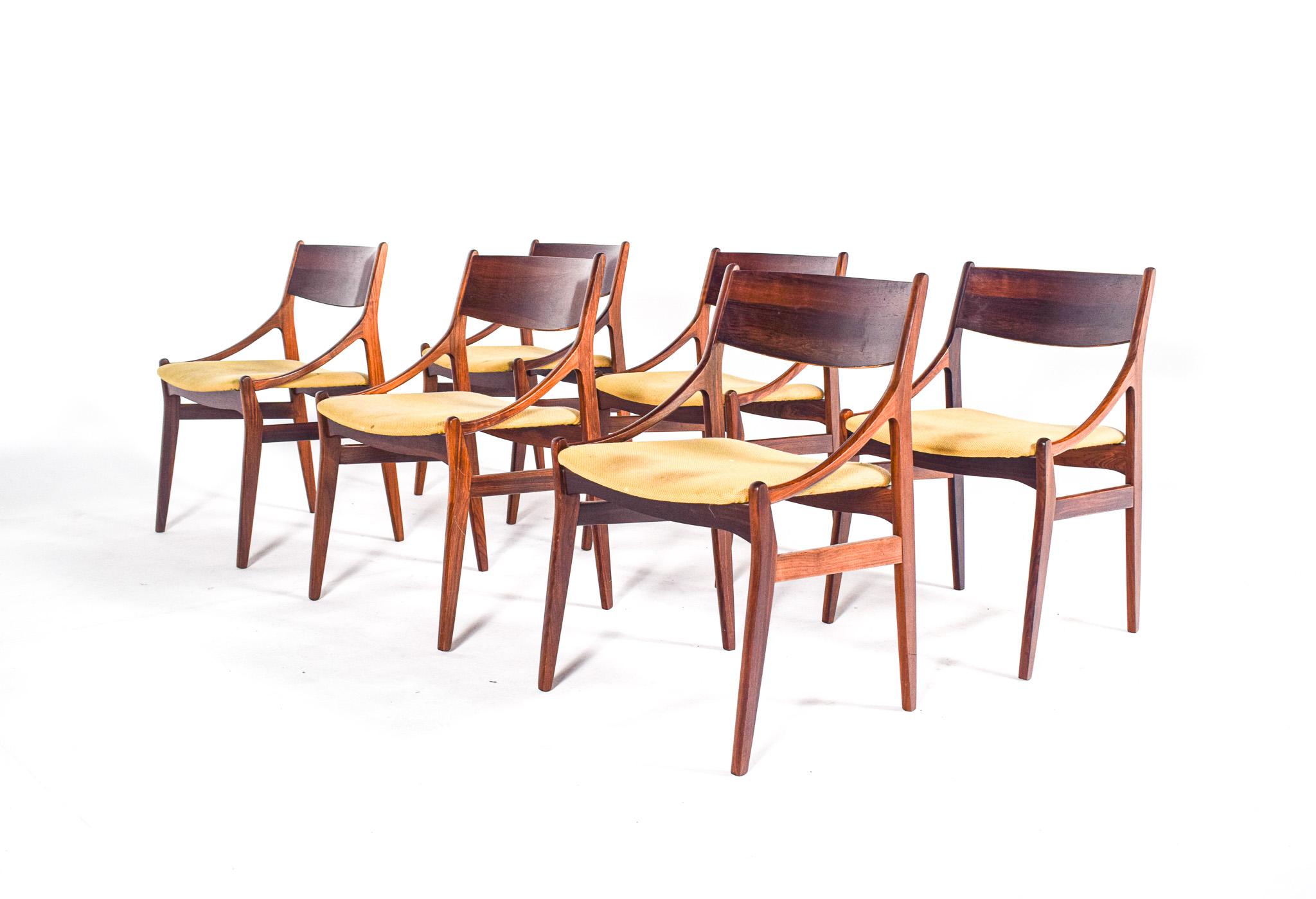 This midcentury set of six dining chairs, designed by Vestervig Erikson for Brdr Tromborg Lystrup, is a quintessential example of 1960s Danish furniture design. Crafted from rosewood, these chairs boast a striking veneer that showcases the intricate