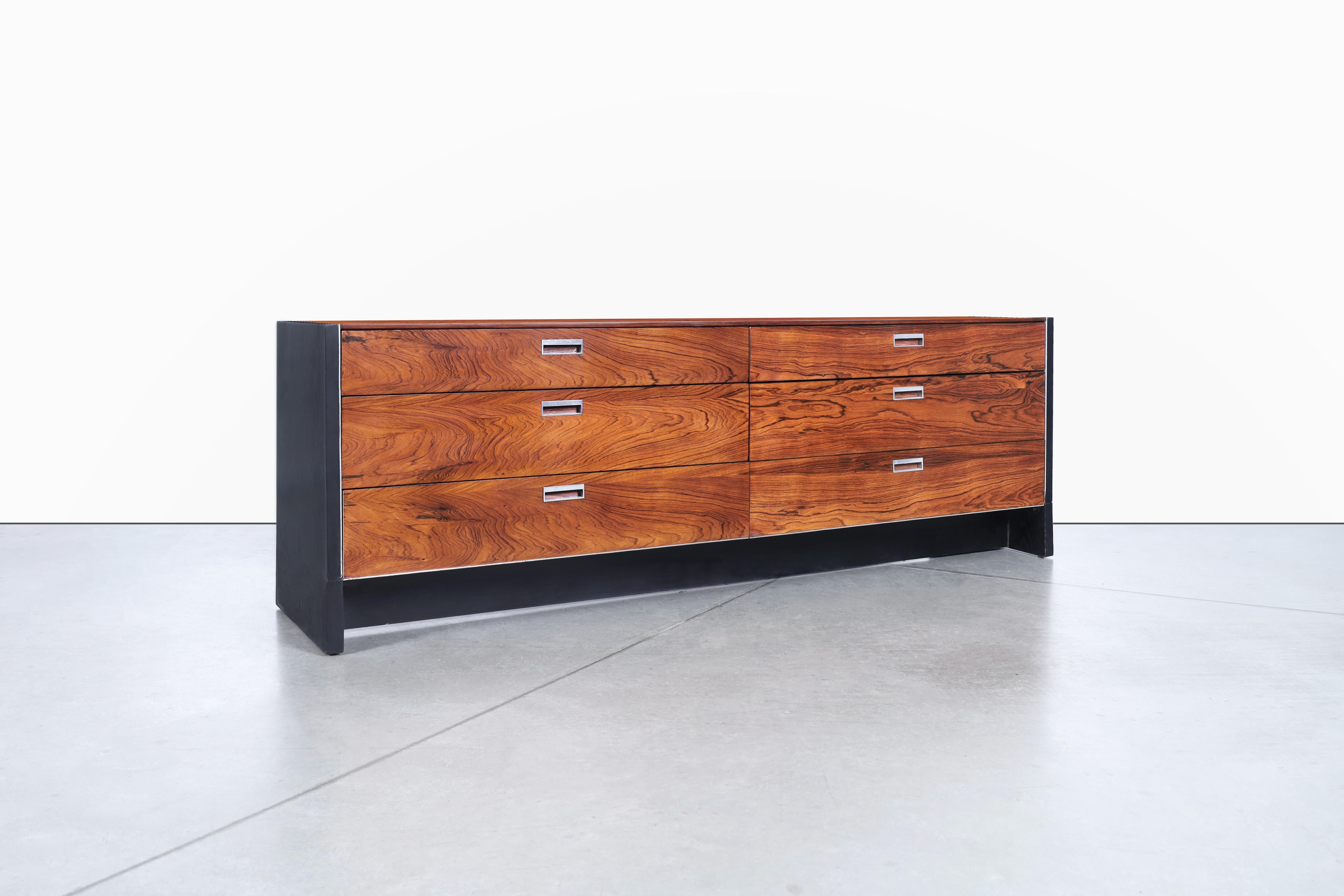 This mid-century rosewood dresser is a true testament to timeless design and craftsmanship. Designed by Robert Baron for Glenn of California in the 1960s, the dresser showcases the unparalleled beauty of Brazilian rosewood. The exquisite grain of