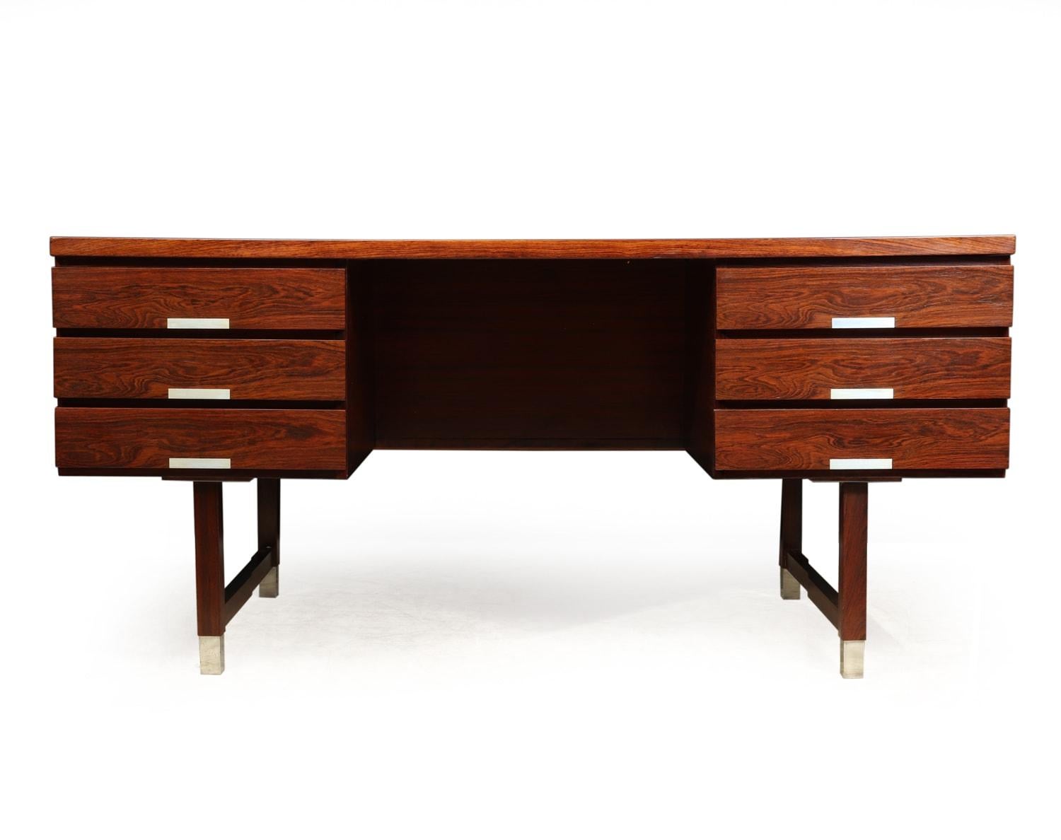 Midcentury rosewood EP401 desk by Kai Kristiansen, circa 1960.
A very stylish desirable rosewood desk produced in the 1960s, having six drawers and open bookshelf to the back making it completely freestanding. Aluminium handles and feet tips, in