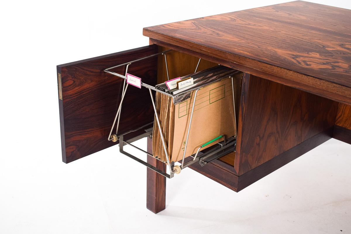 Midcentury Rosewood executive desk by Gunnar Falsig for Falsigs Mobelfabrik, , designed in the 60s. The desk has three drawers on each side at the front, a door and shelf at the backside. Elegant desk with straight lines and beautiful handles.