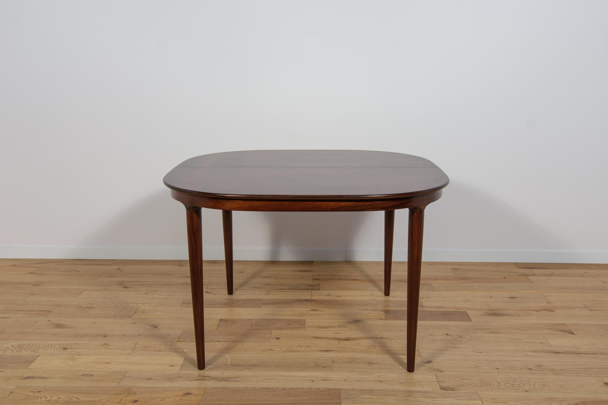 The table produced in the 1960s in Denmark by Skovmand & Andersen. The tabel made of rosewood with a light form and interesting grain. It is characterized by a unique design and high craftsmanship, which is evidenced by reinforced profiled edges and