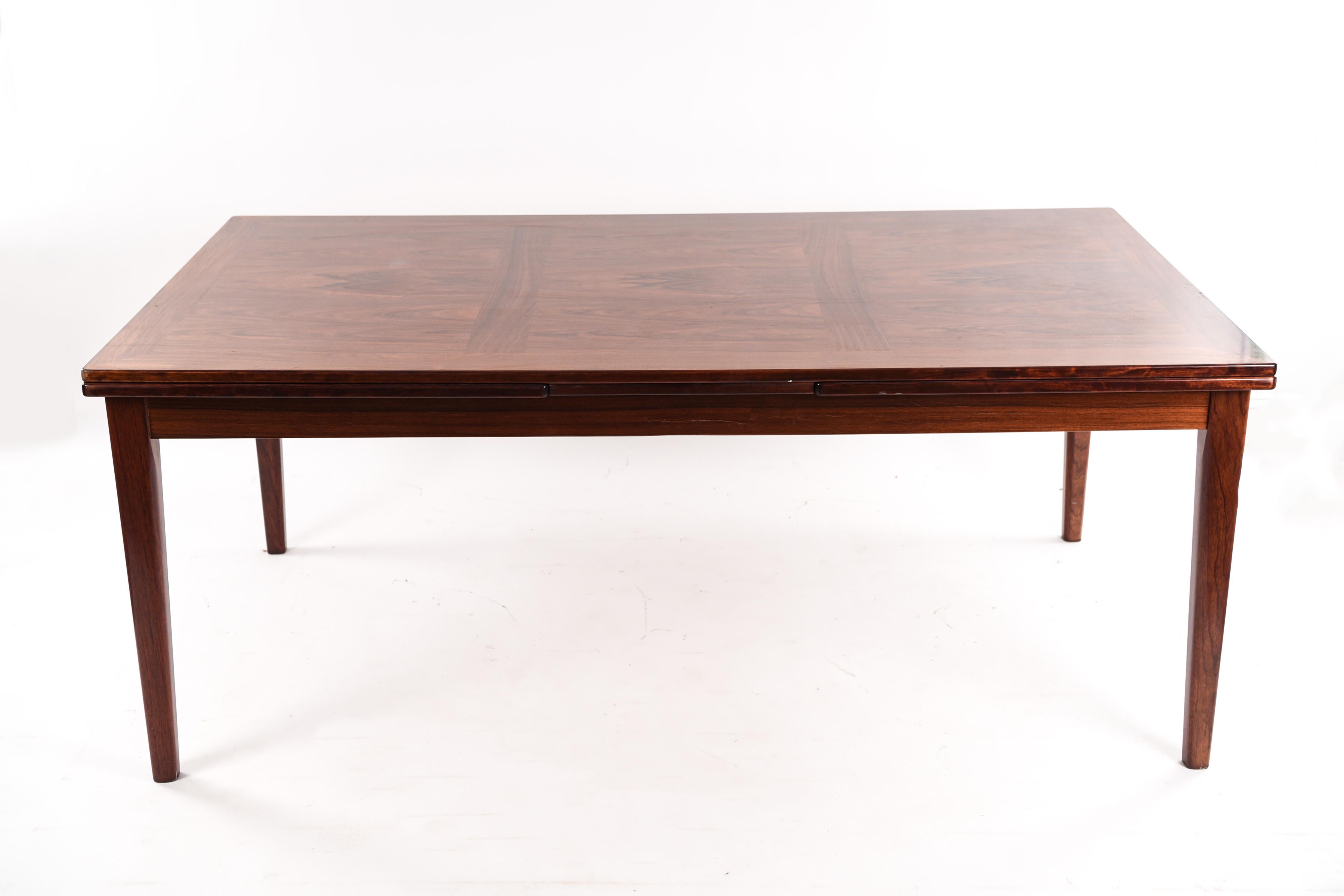 A beautiful modern extending dining table, fit to accommodate many guests. A simple, clean form.
