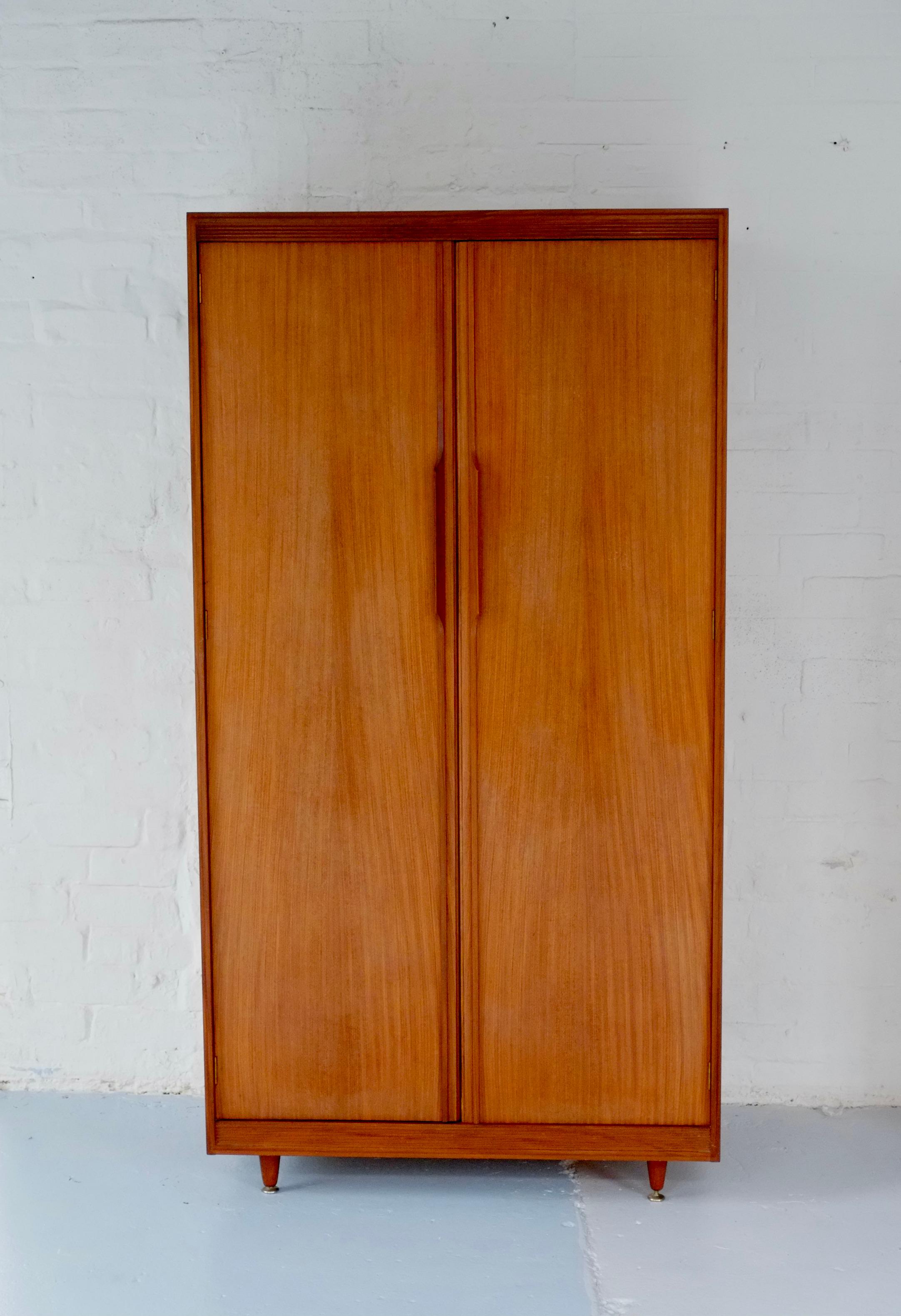 A beautiful fitted mid century wardrobe by Arthur Edwards for White and Newton. England C1960. The matching dressing table is featured in the 1961 book Contemporary Design in Woodwork. 

This piece is beautifully made in two tones of wood - i think