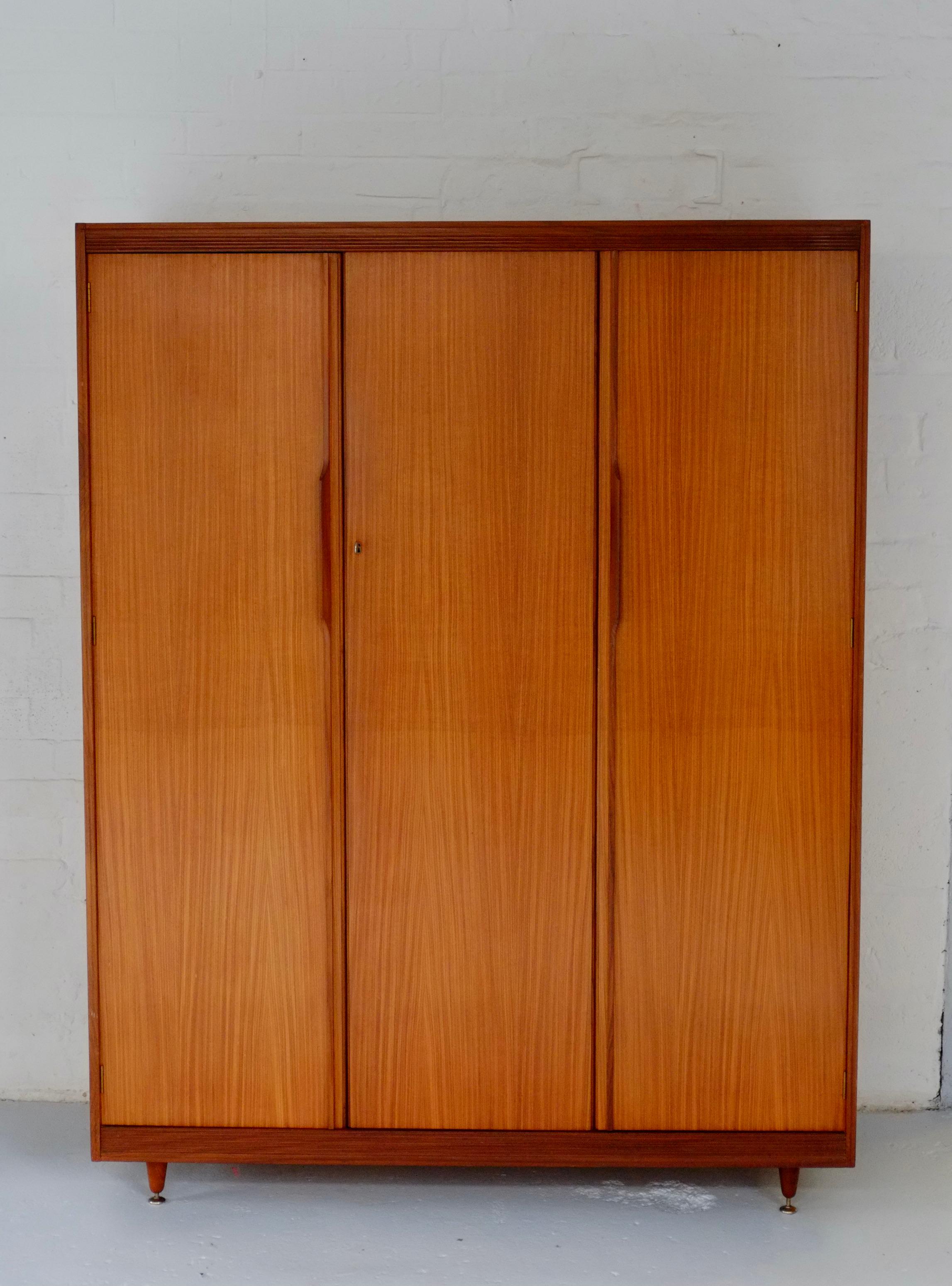 A beautiful large mid century wardrobe by Arthur Edwards for White and Newton. England C1960. The matching dressing table is featured in the 1961 book Contemporary Design in Woodwork. 

This piece is beautifully made in two tones of wood - I think