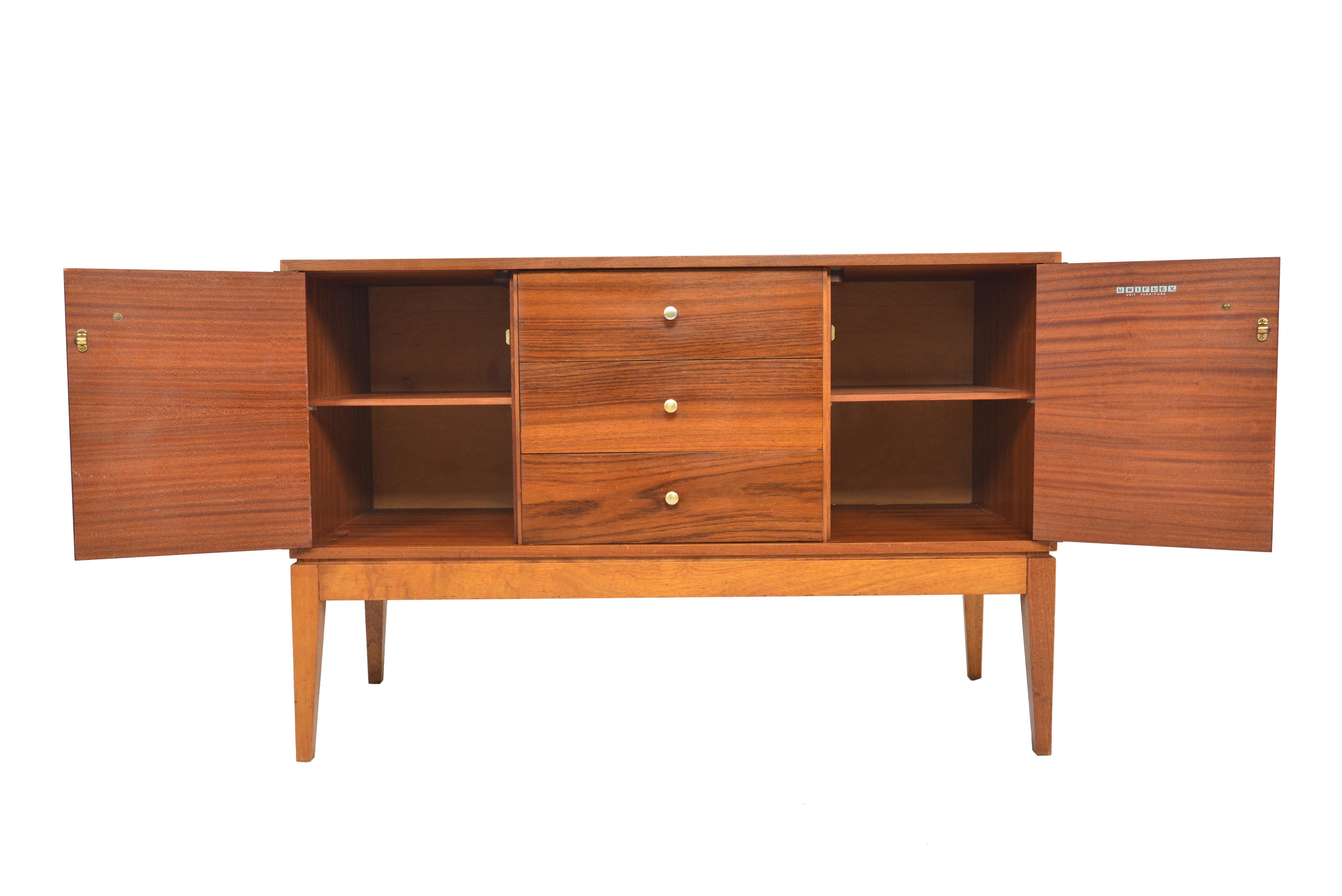 This beautiful low midcentury dresser was designed by Uniflex. The case is expertly crafted in mahogany and stands on a tapered base. Drawer fronts are crafted in rosewood with original brass pulls. In excellent original condition.

 