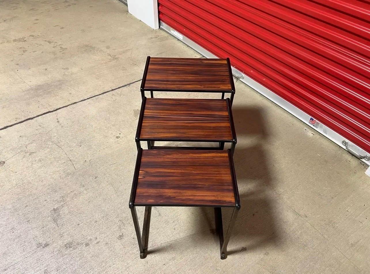 Available for purchase is a truly unique set of rosewood nesting tables. these tables are not only stylish but also lightweight