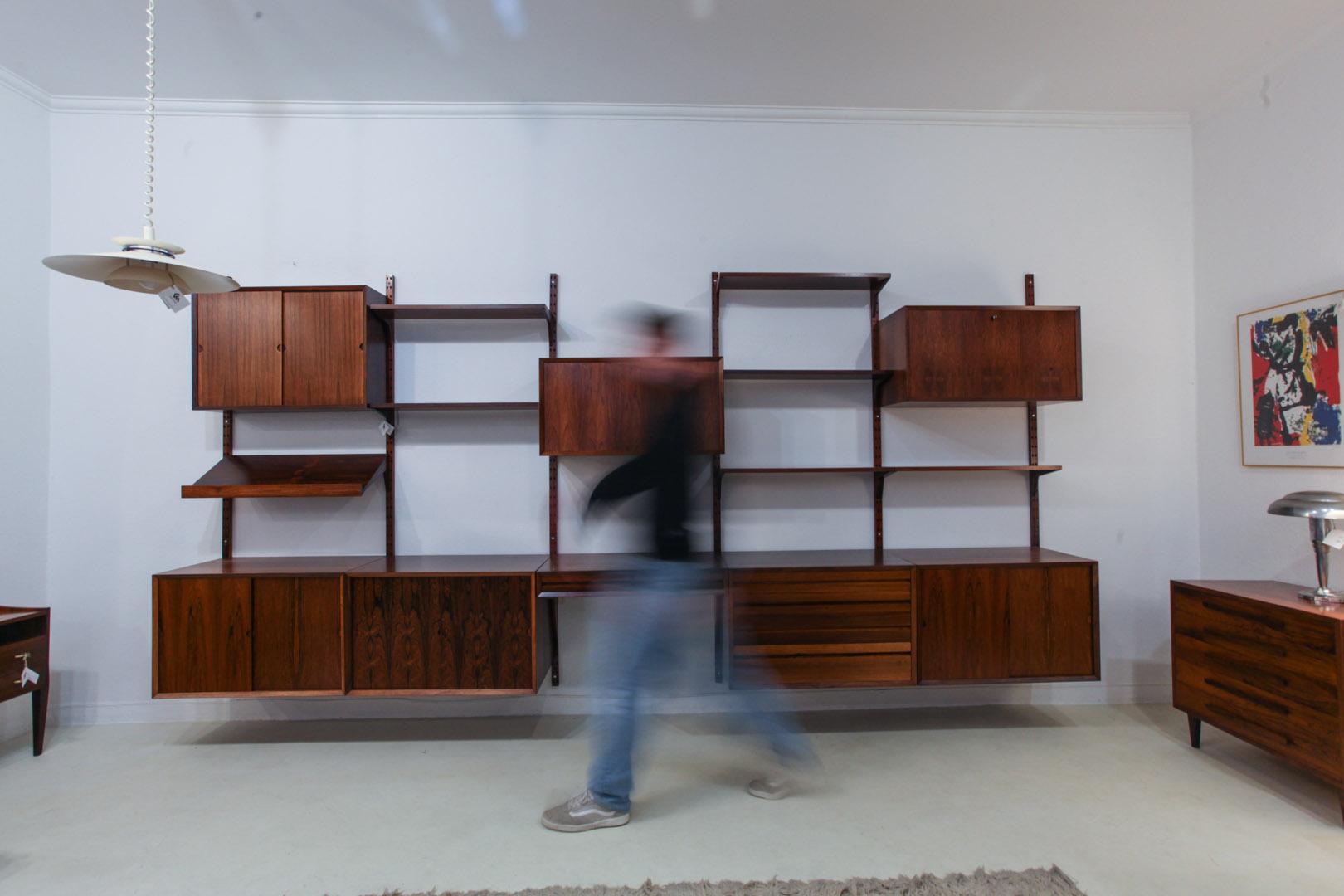 Danish modern rosewood floating wall unit designed by Poul Cadovius for Royal System. 6 multiple shelves and 8 compartments and a large shelve that can be used as desk. Very complete set, with a lot of different storage options.