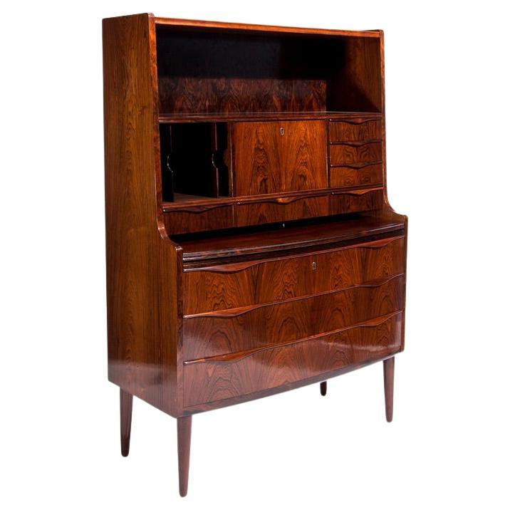 A fine mid century rosewood secretaire designed by Erling Torvits, Danish 1950’s. A beautiful piece of danish design a lovely practical secretaire/ bureau with amazing deep rich colour and patina to the rosewood. A single top shelf above a