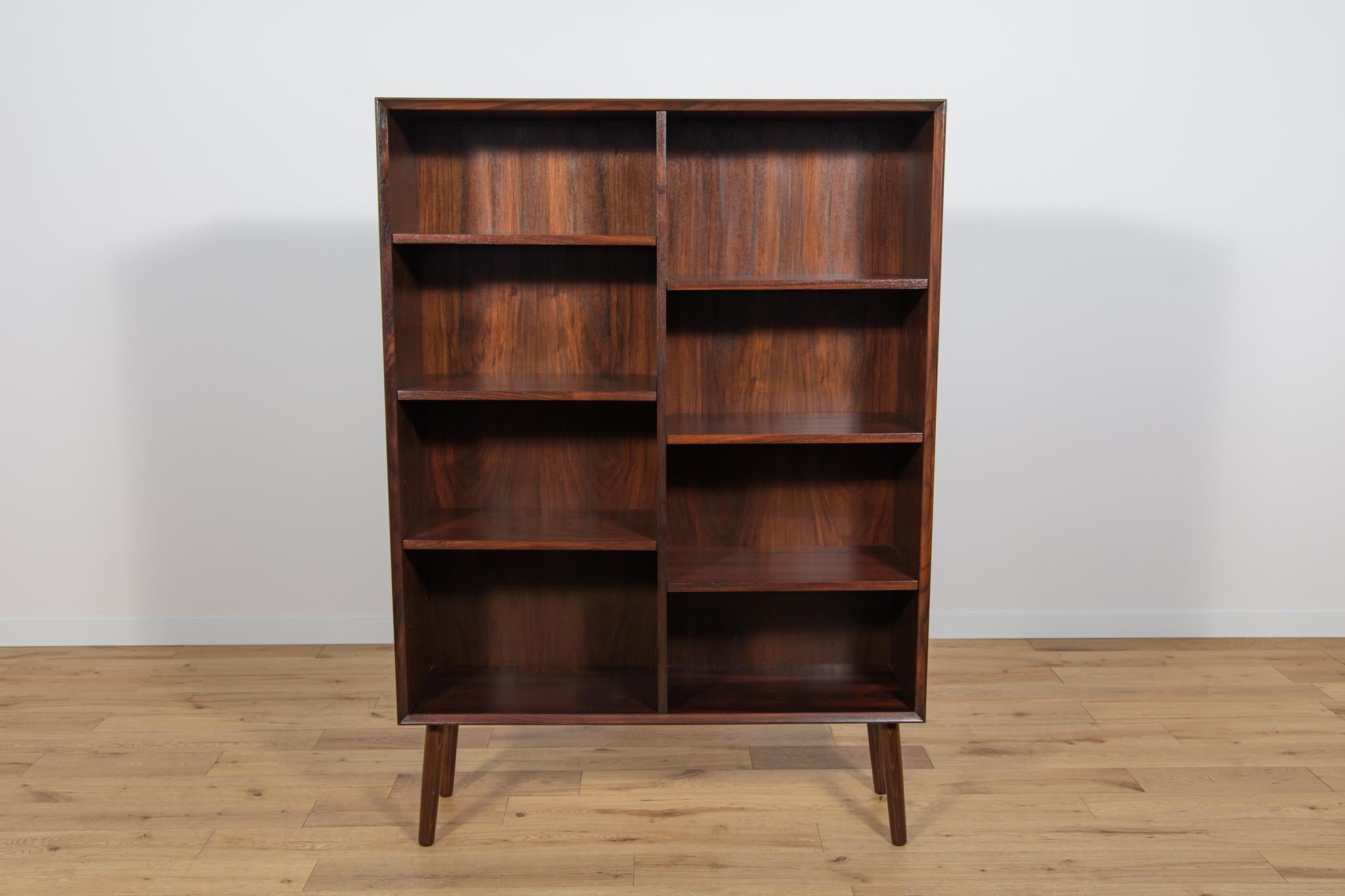 Librería de palisandro fabricada en Dinamarca en la década de 1960. La librería tiene un interesante veteado y bordes contorneados. Los muebles han sido completamente renovados, limpiados de la superficie antigua, acabados con aceite danés de gran