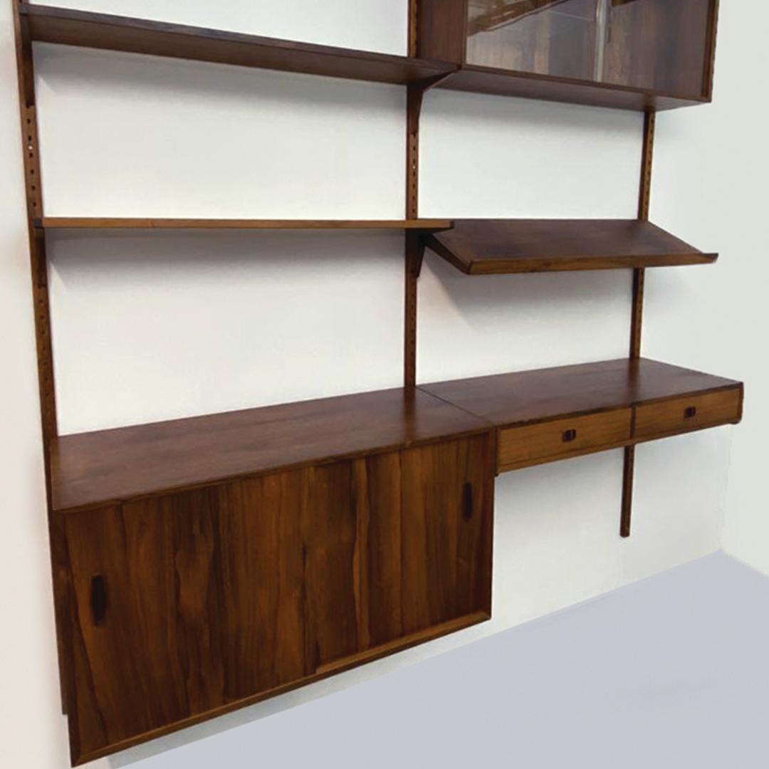 An impressive Rosewood Domi 9 Modular Shelving System, designed by Nils Jonsson for Troeds in the 1960's.

A stunning piece of furniture enhances any interior, comprising of a three drawer cupboard, double glass fronted sliding door display cabinet.