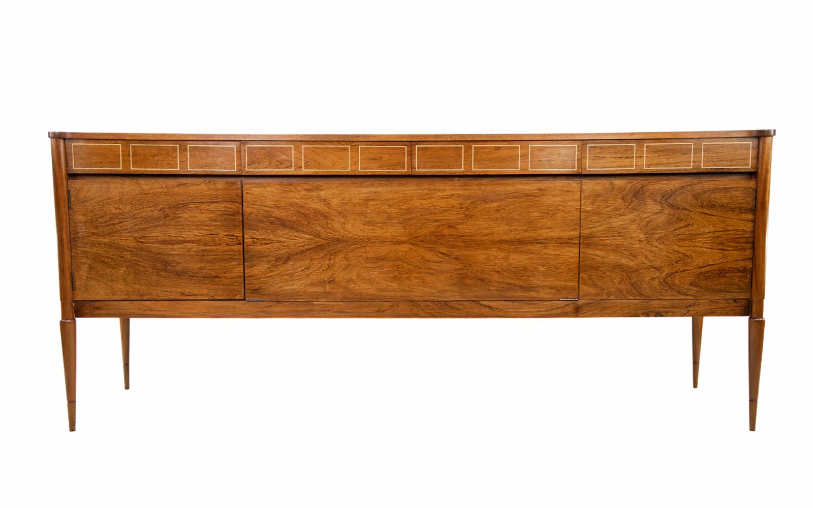 Mid-century rosewood sideboard.

A Danish design mid-20th-century rosewood sideboard.

An excellent design with a unique shape to the top surface. Beautiful rosewood detail and grain with a rectangle pattern running across the top