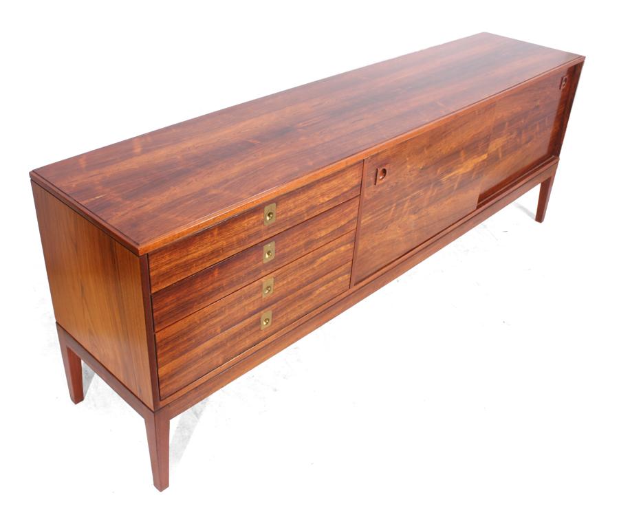 Midcentury rosewood sideboard by Robert Heritage for Archie Shine
A rosewood sideboard designed by Robert Heritage and produced by Archie Shine for Heals ( label inside) in the 1960s, the sideboard features four drawers to the left with brass inset