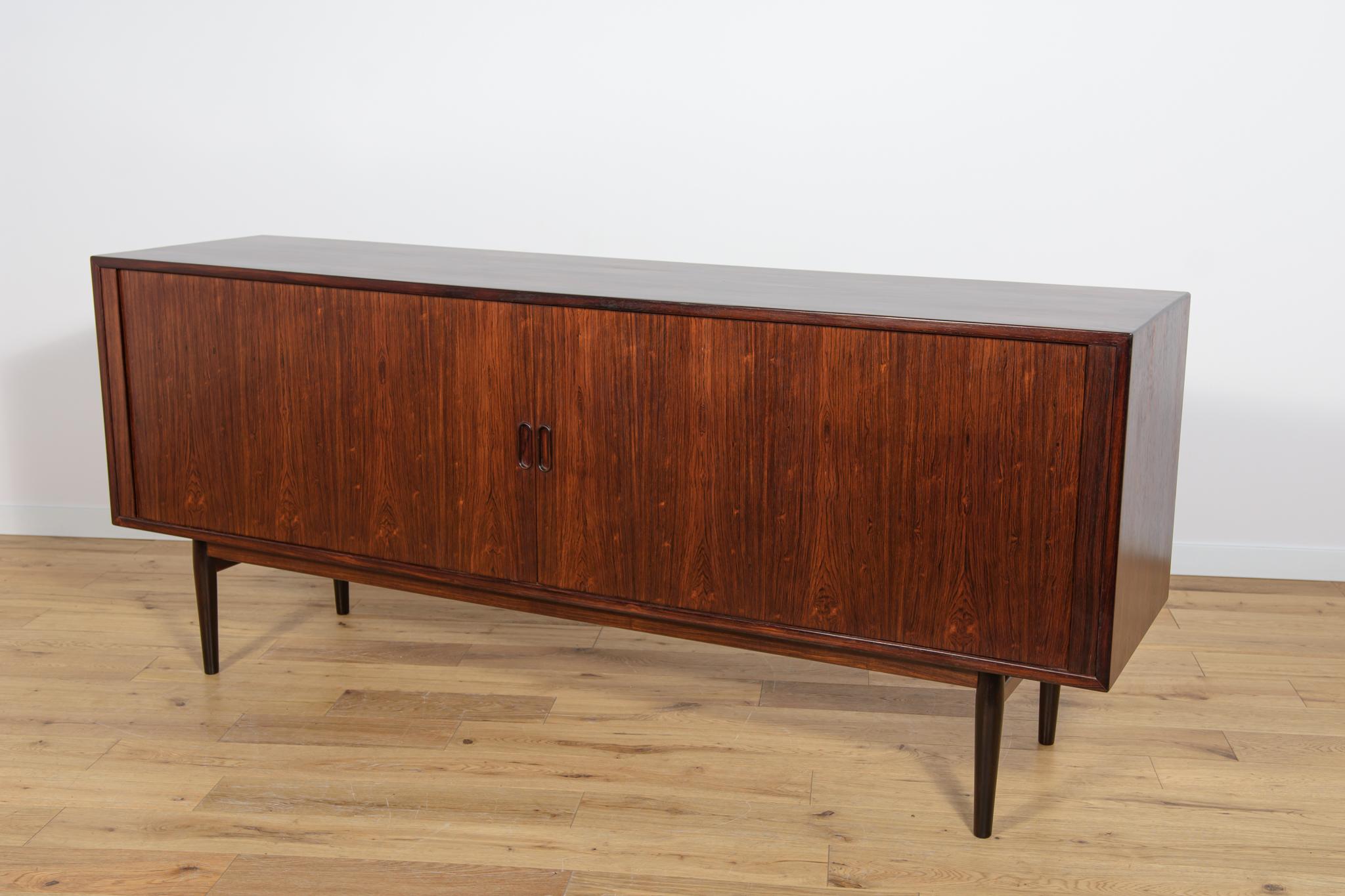 A unique Model 37 sideboard designed by Arne Vodder, produced in the 1960s in the Danish Sibast factory. Sideboard has an interesting roller door system, inside there are shelves and two drawers. Furniture made of rosewood with profiled handles. The