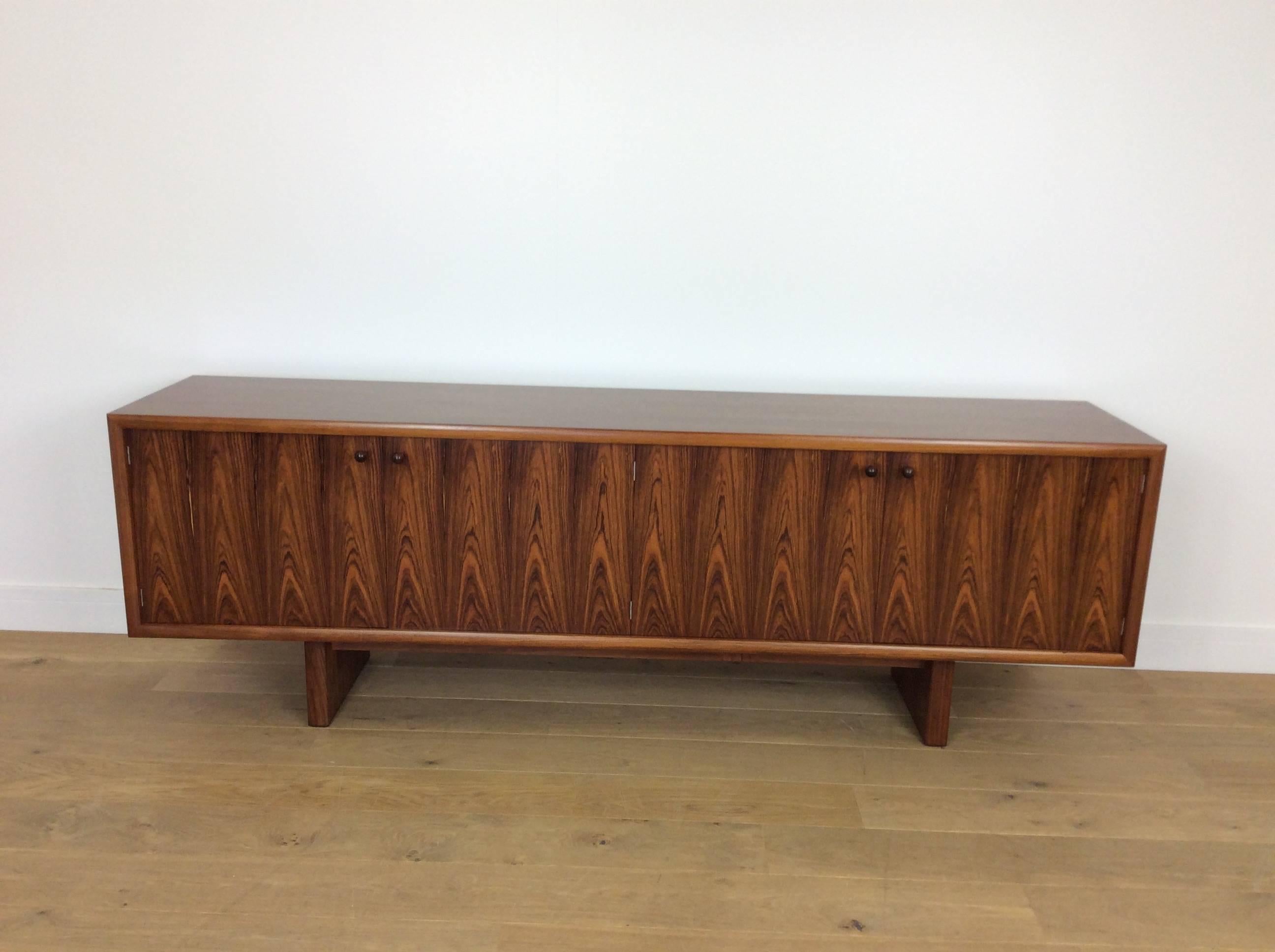 A pair of midcentury sideboards credenzas.
An extremely rare pair of sideboards design by Martin Hall and produced by Gordon Russell in the most stunning rosewood with contrasting maple interior.
Model GR75
British, circa 1975
Measures: 71 cm H,